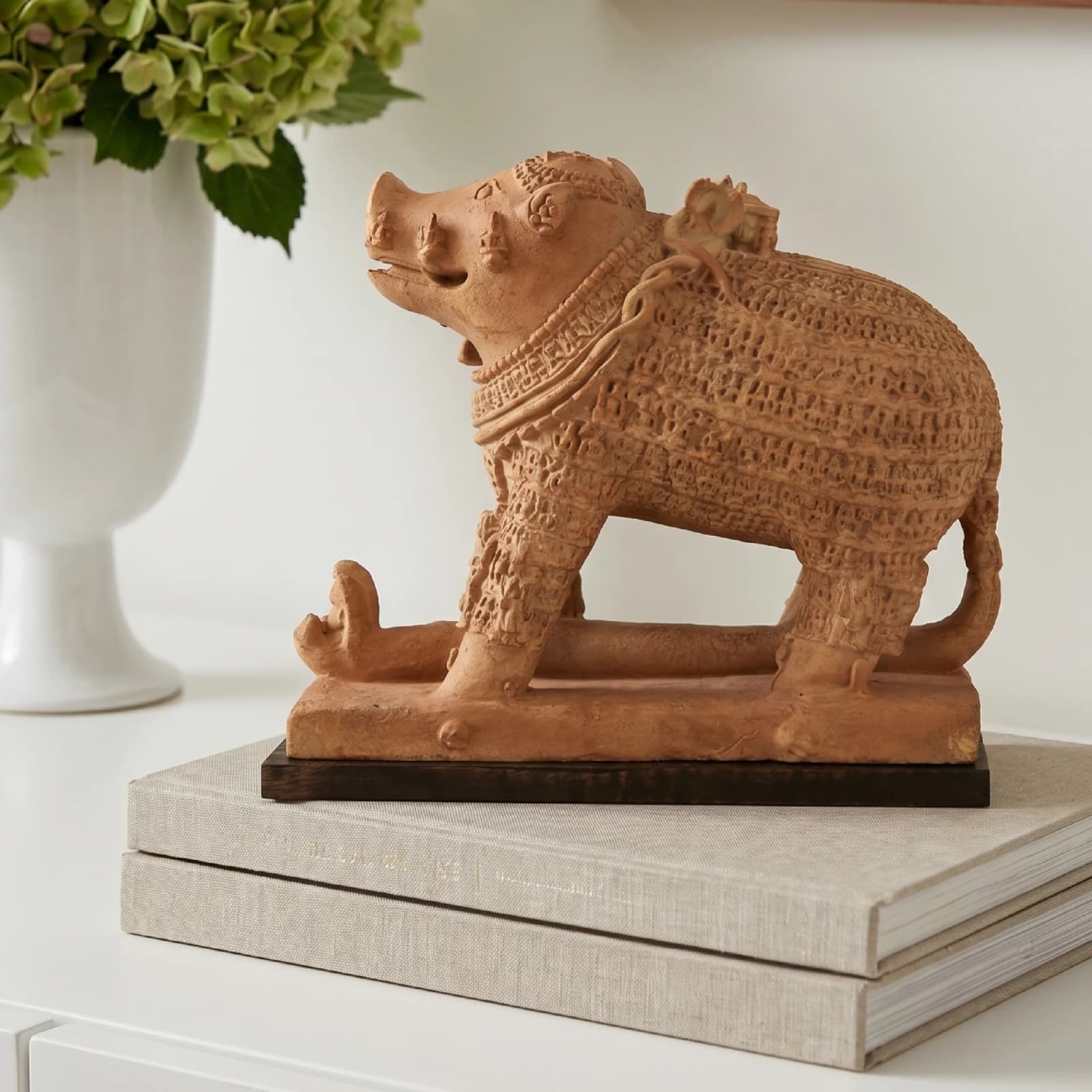 A side profile of the Adi Varaha Sculpture, a terracotta-style replica showing Vishnu as a boar rescuing Bhudevi.