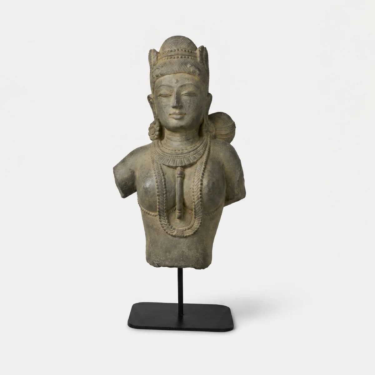 A front-facing view of the Female Figure Bust Sculpture, a stone composite replica featuring intricate Chola-style jewelry and detailing.