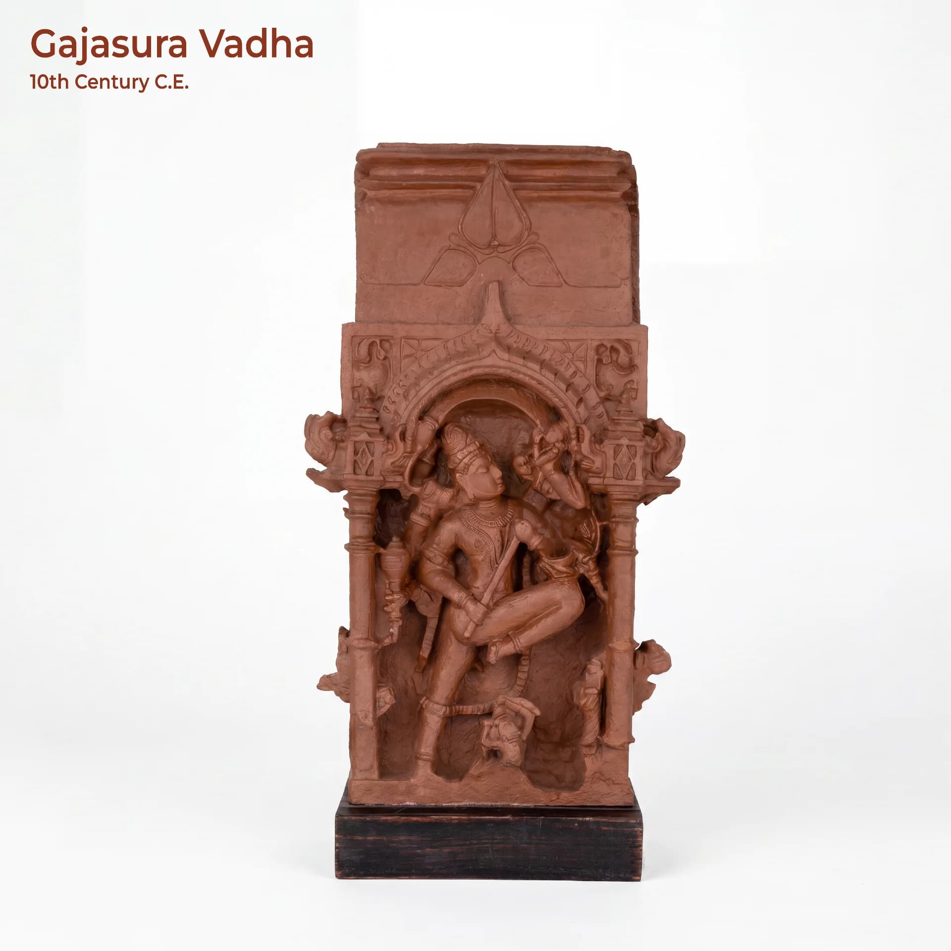 A full front view of the Gajasura Vadha Sculpture, a terracotta-style museum replica depicting Shiva in a dynamic pose.