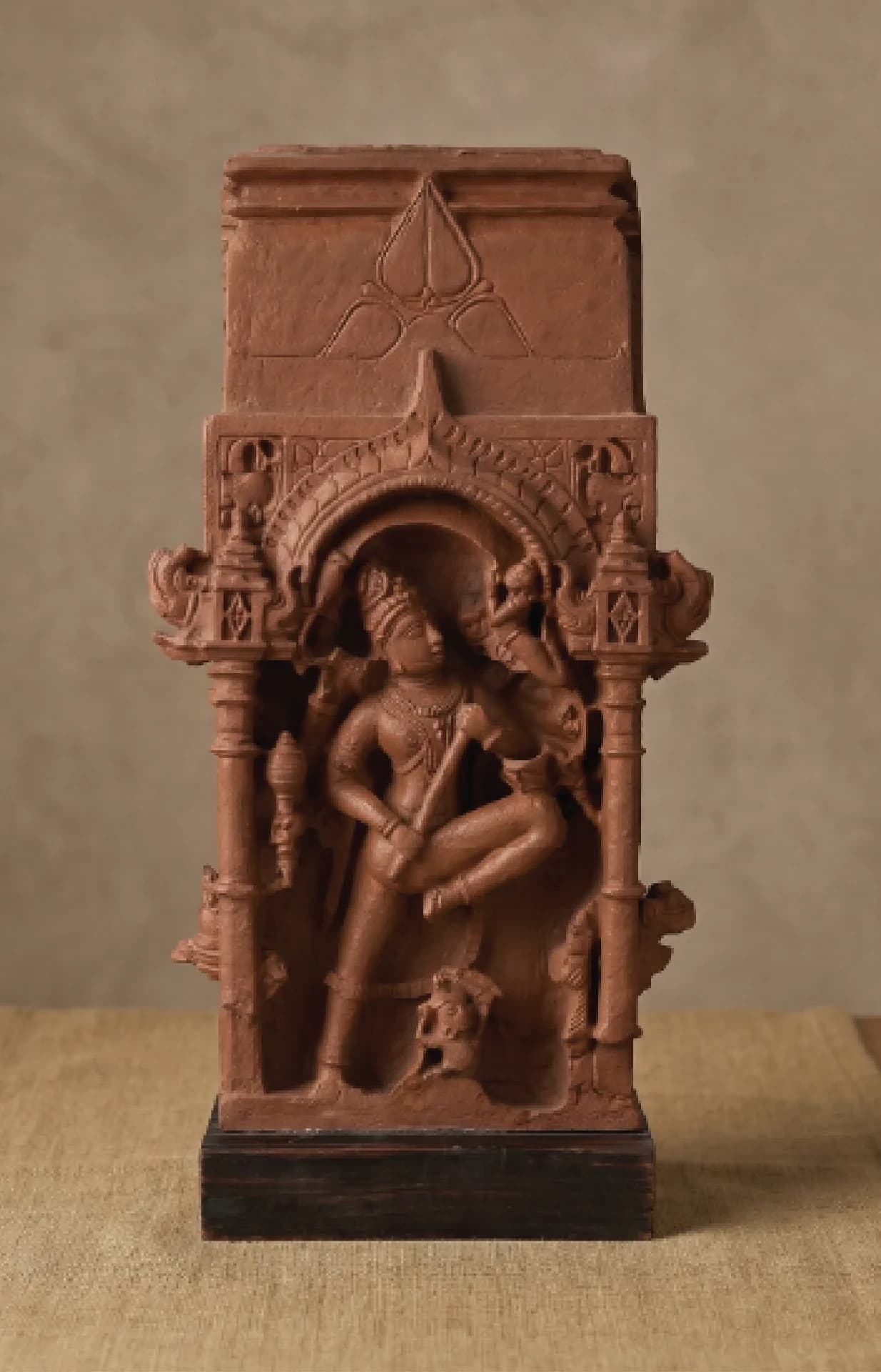 A front-facing view of the Gajasura Vadha Sculpture, a terracotta-style museum replica featuring intricate temple relief carvings of Shiva.