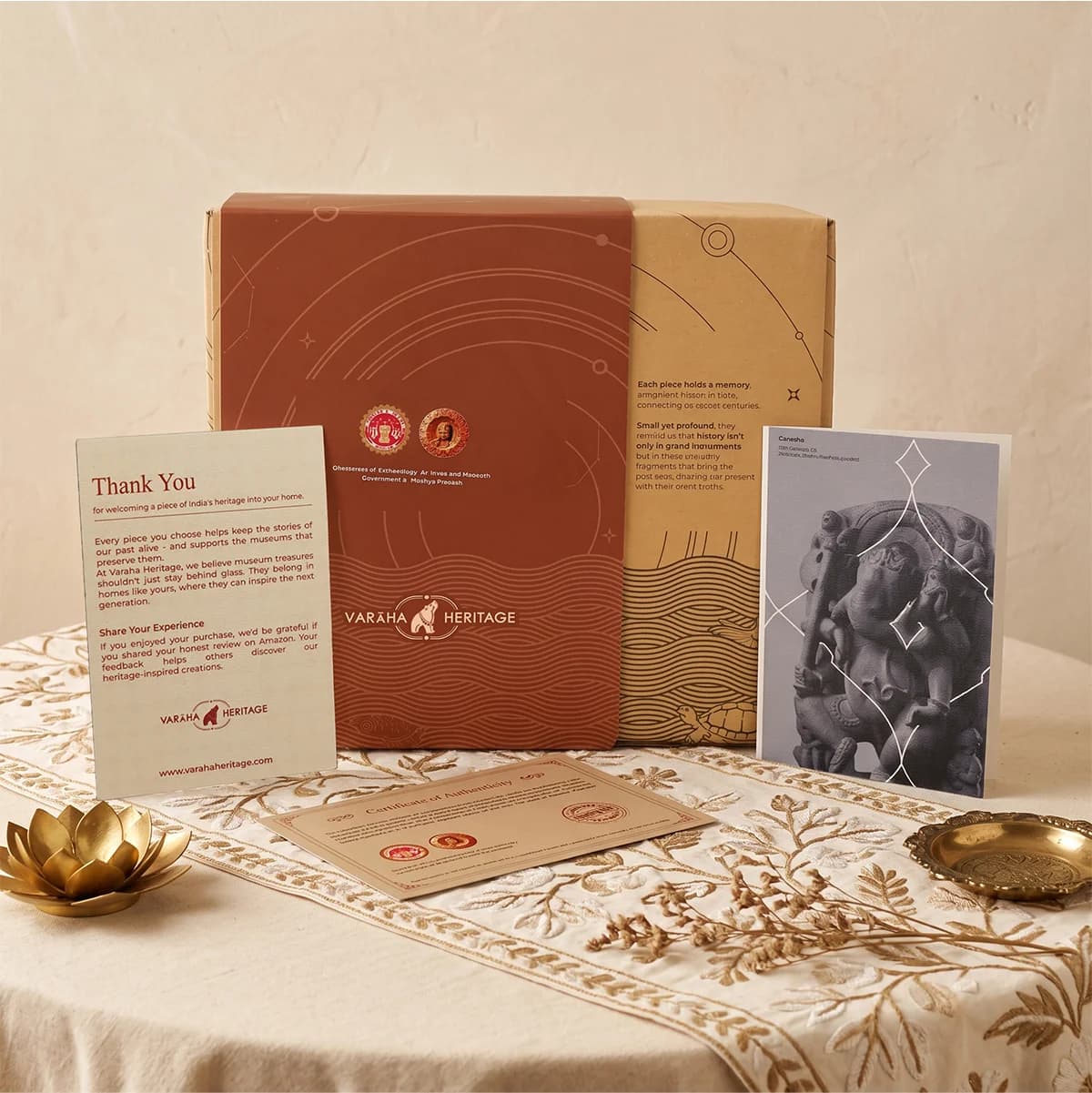 The Ganesha Sculpture packaging includes a branded box, certificate of authenticity, and an informational card on a table.