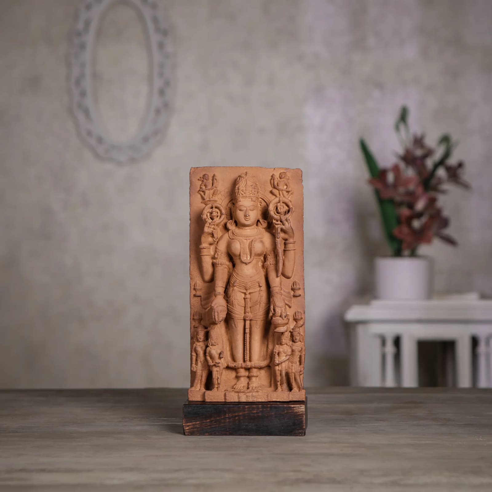 A front-facing view of the Gauri Parvati Sculpture, a detailed stone composite replica featuring intricate Pratihara-style carvings on a wooden base.