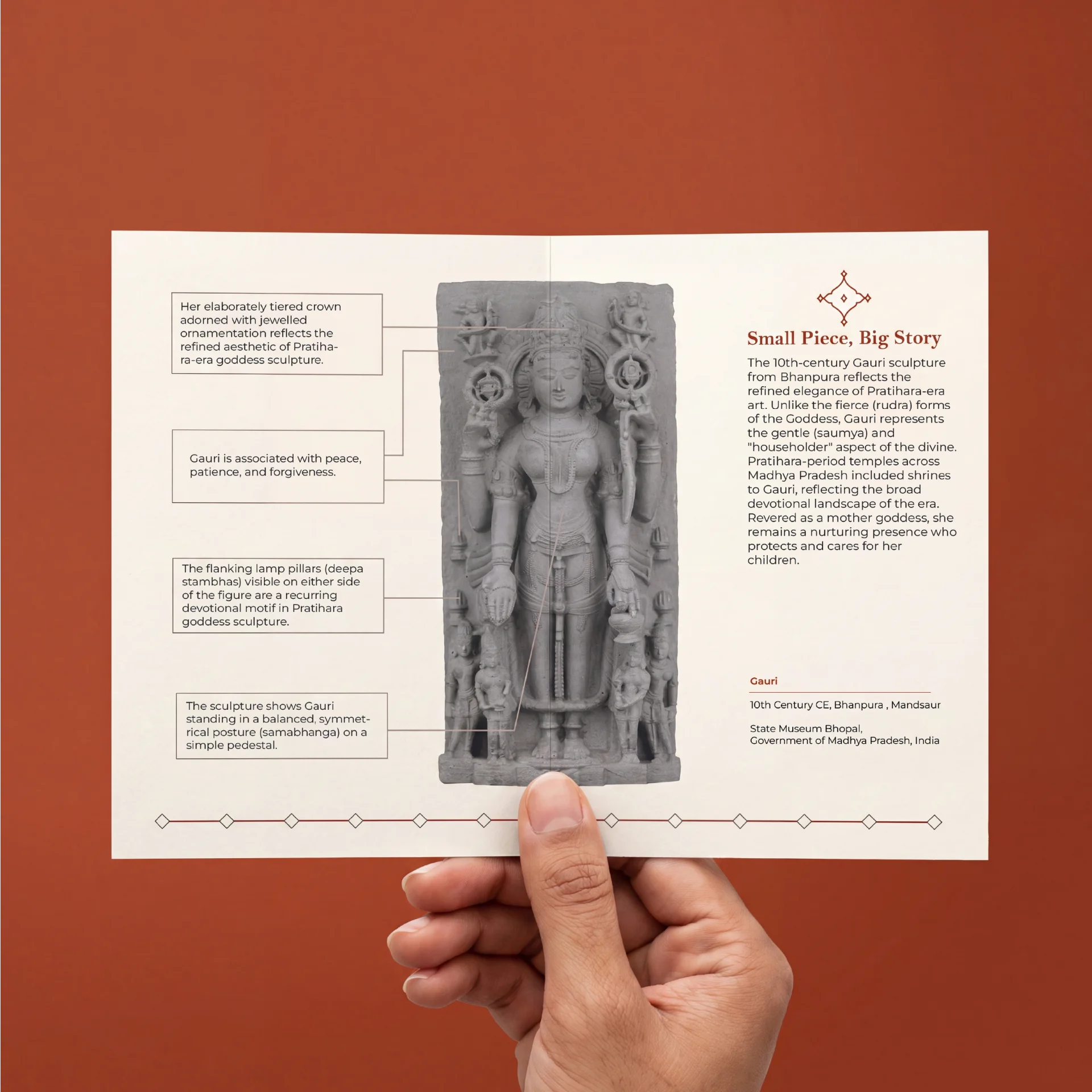 A hand holds a brochure featuring the Gauri Parvati Sculpture, a stone composite museum replica with detailed historical annotations.