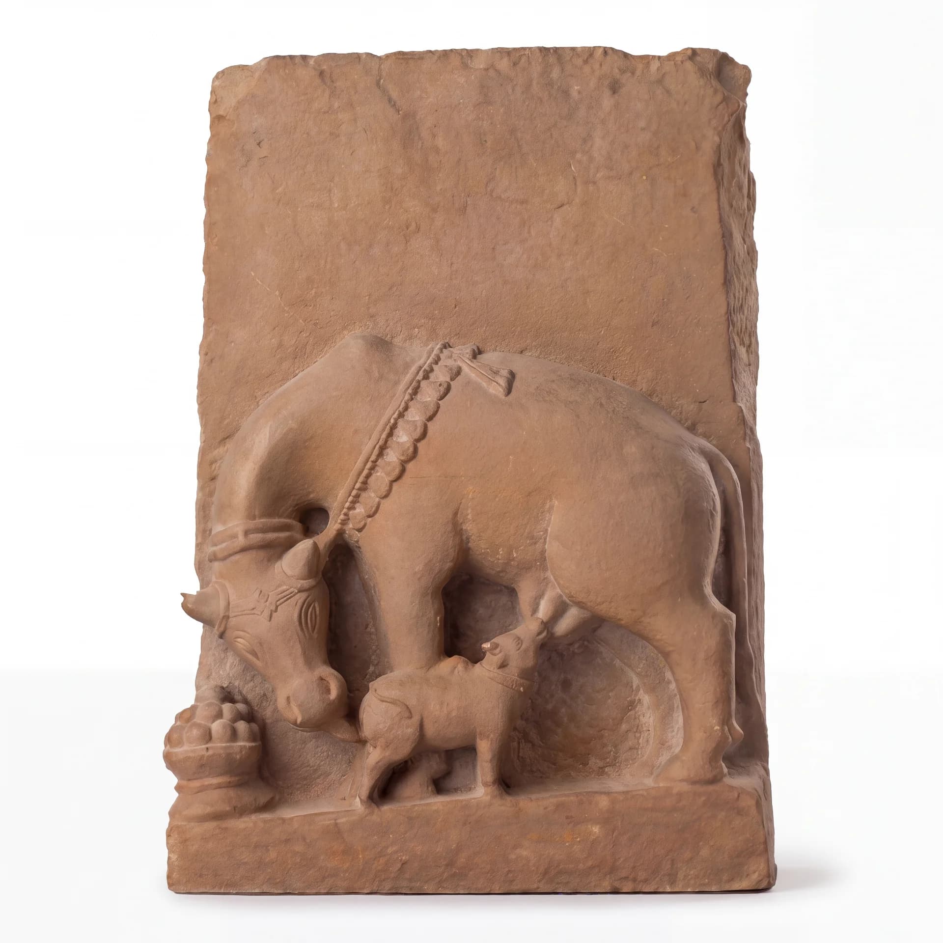 A front-facing view of the Kamdhenu Sculpture, a hand-finished stone composite relief depicting a divine cow nursing her calf.