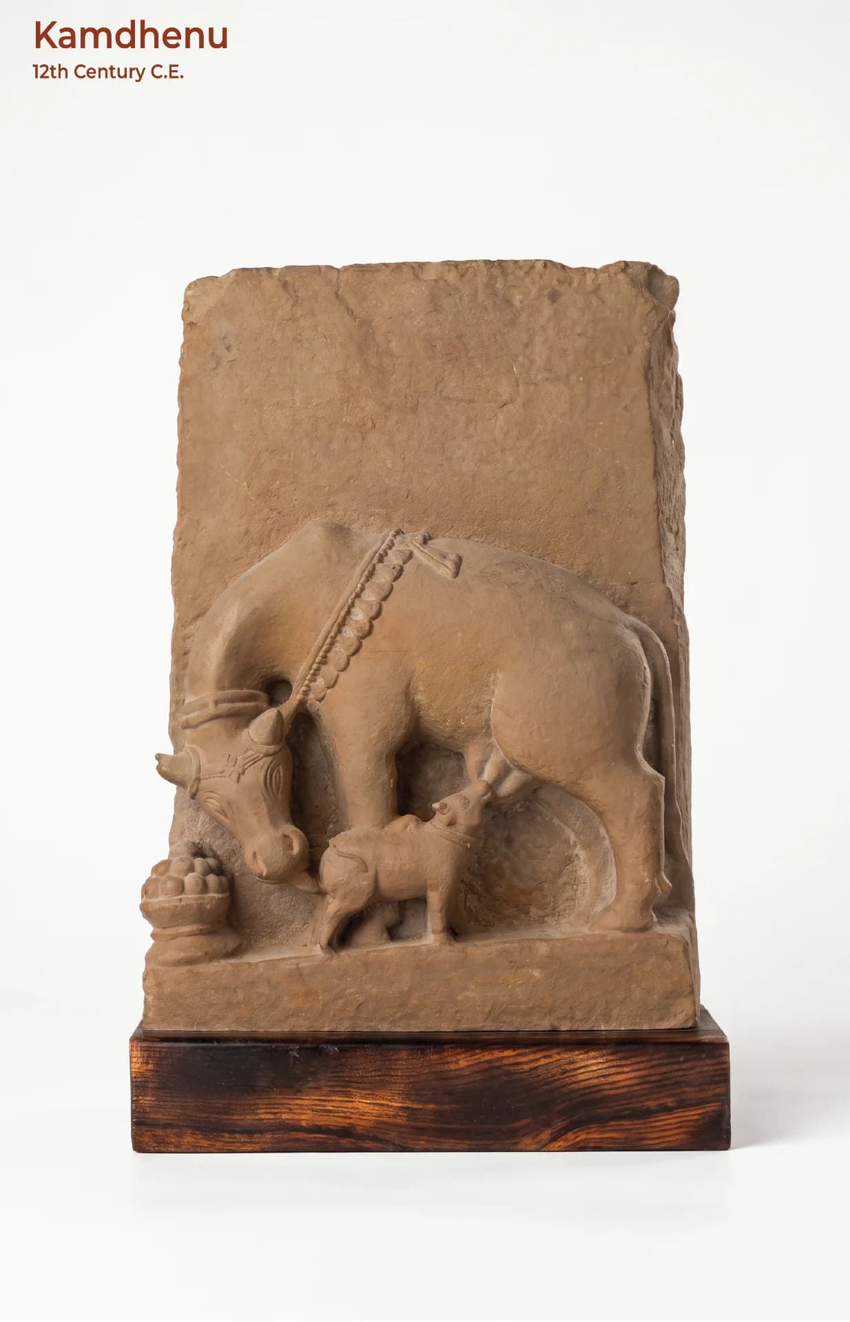 A front-facing view of the Kamdhenu Sculpture, a hand-finished stone composite replica showing a cow nursing her calf.