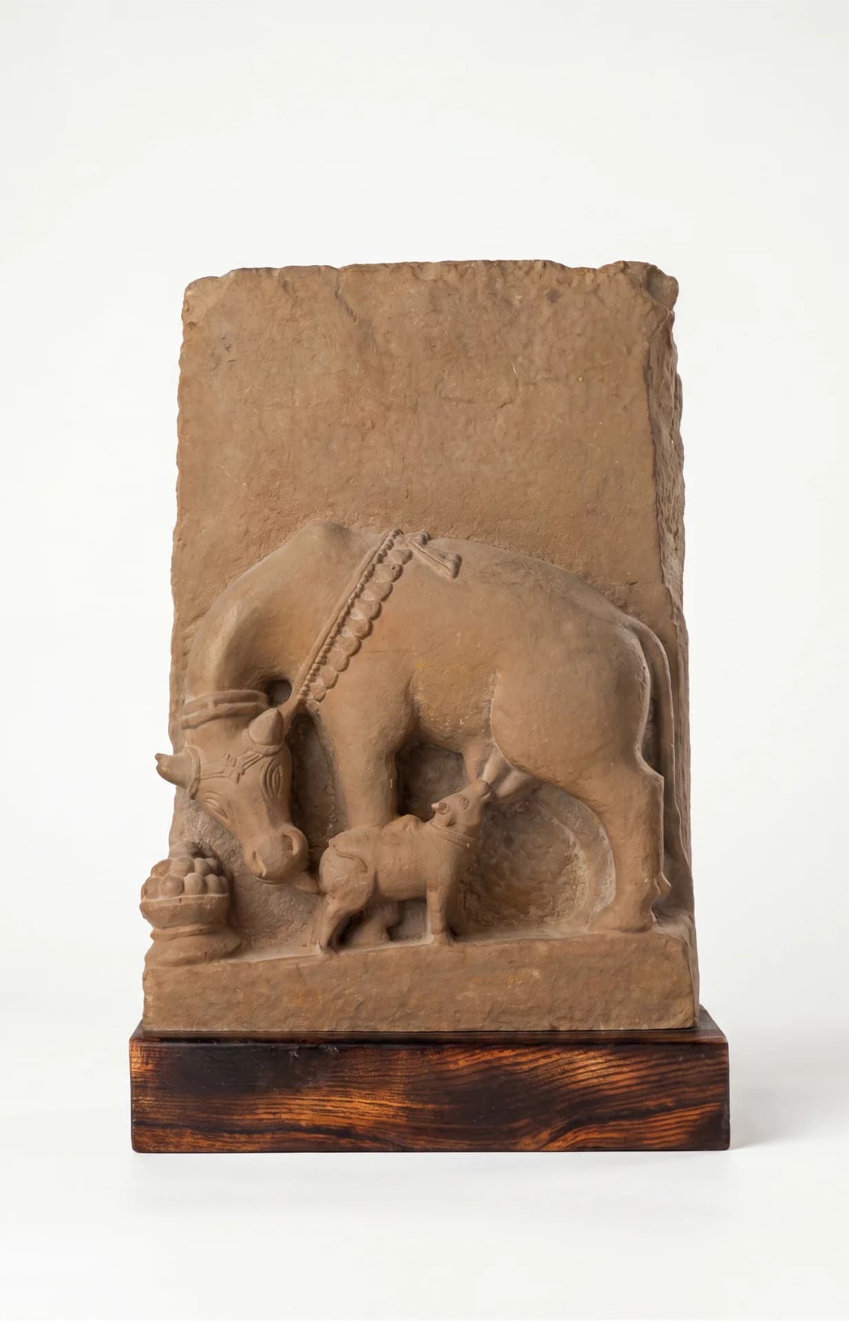 A front view of the Kamdhenu Sculpture, a stone composite museum replica depicting a divine cow nursing her calf.