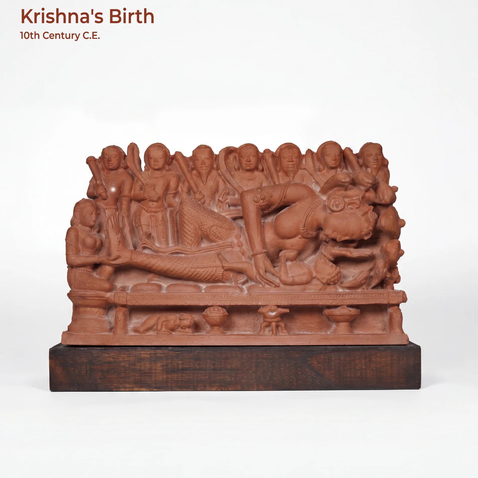 A terracotta-toned Krishna's Birth Sculpture replica showing Devaki with her newborn, intricately carved in a classic 10th-century style.