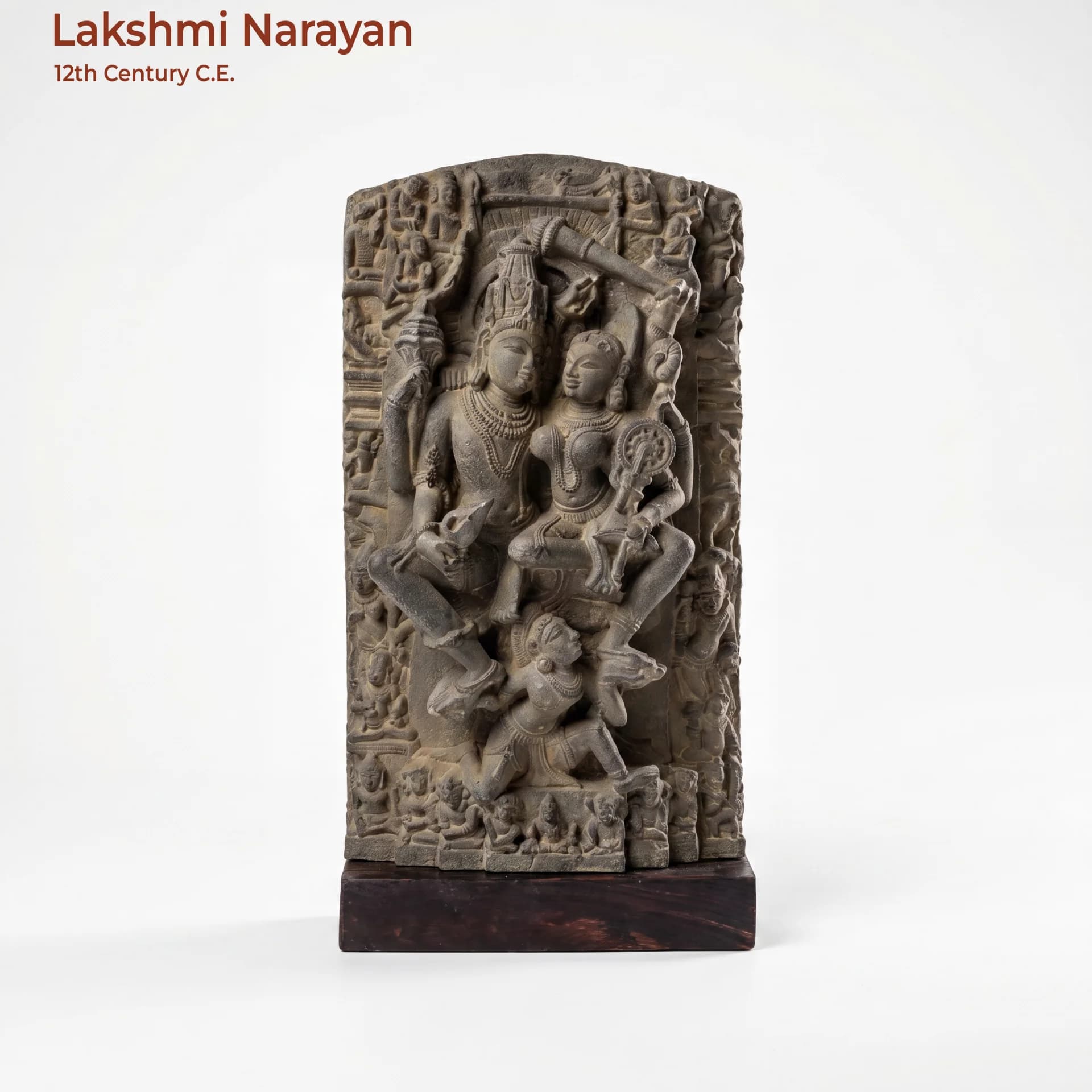 A full-front studio view of the Lakshmi Narayan Sculpture, a detailed stone composite replica featuring intricate medieval iconography.