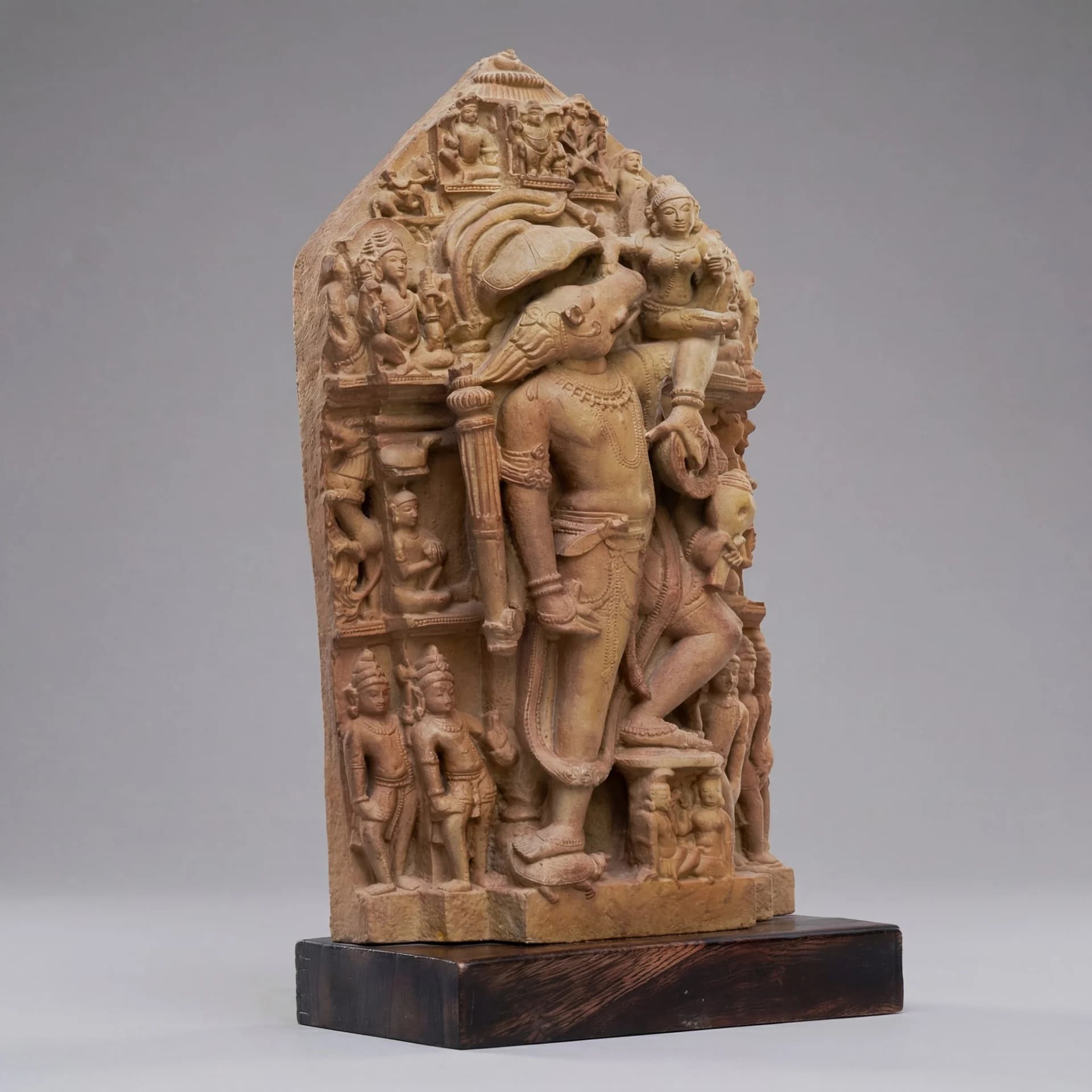 A three-quarter view of the Nar Varaha Sculpture, a stone composite replica showing the man-boar deity carrying Bhudevi.