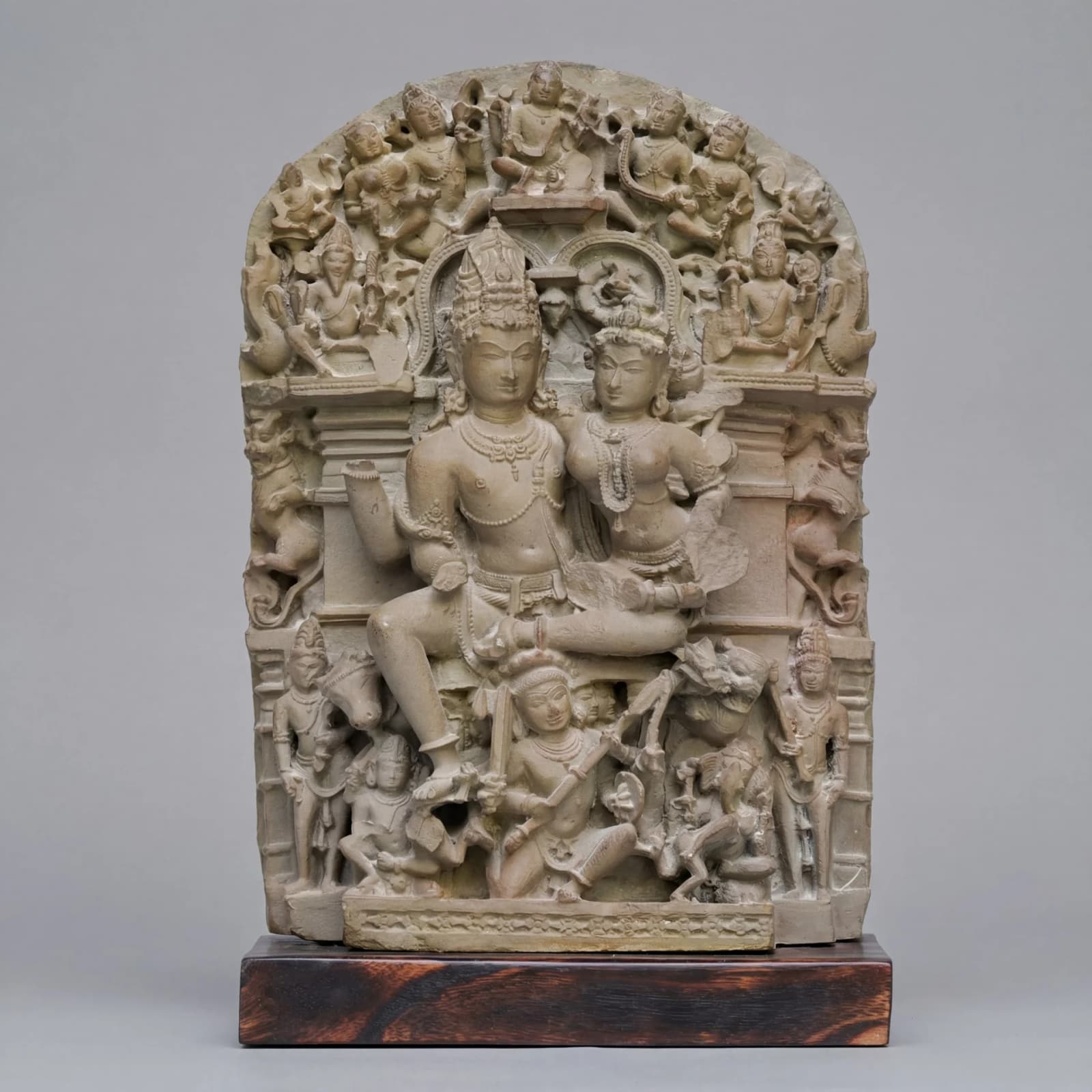 A front-facing view of the stone composite Ravananugraha Sculpture showing intricate 11th-century style carvings of Shiva and Ravana.