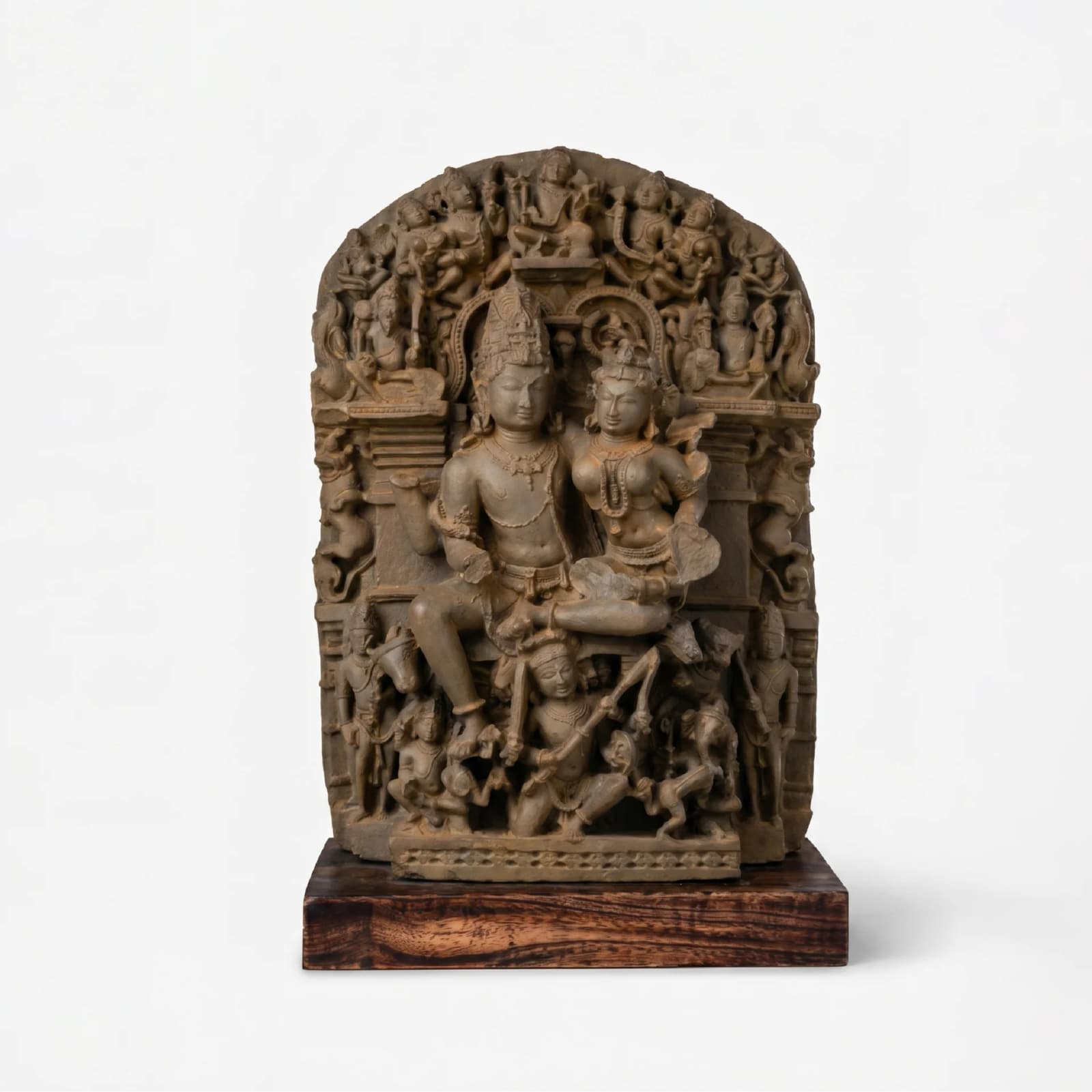 A front view of the stone composite Ravananugraha Sculpture, showcasing intricate 11th-century temple art details on a wooden base.