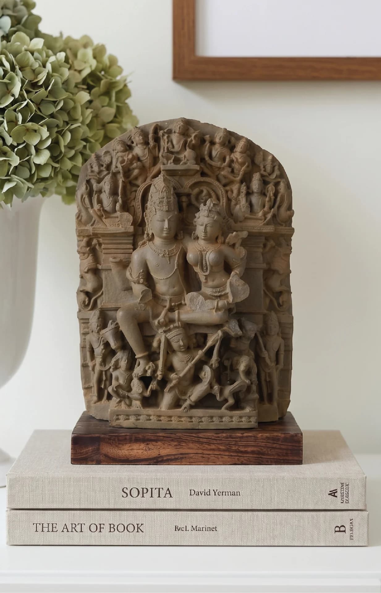 A front-facing view of the Ravananugraha Sculpture, a hand-finished stone composite museum replica depicting Shiva and Parvati seated on a teak wood base.