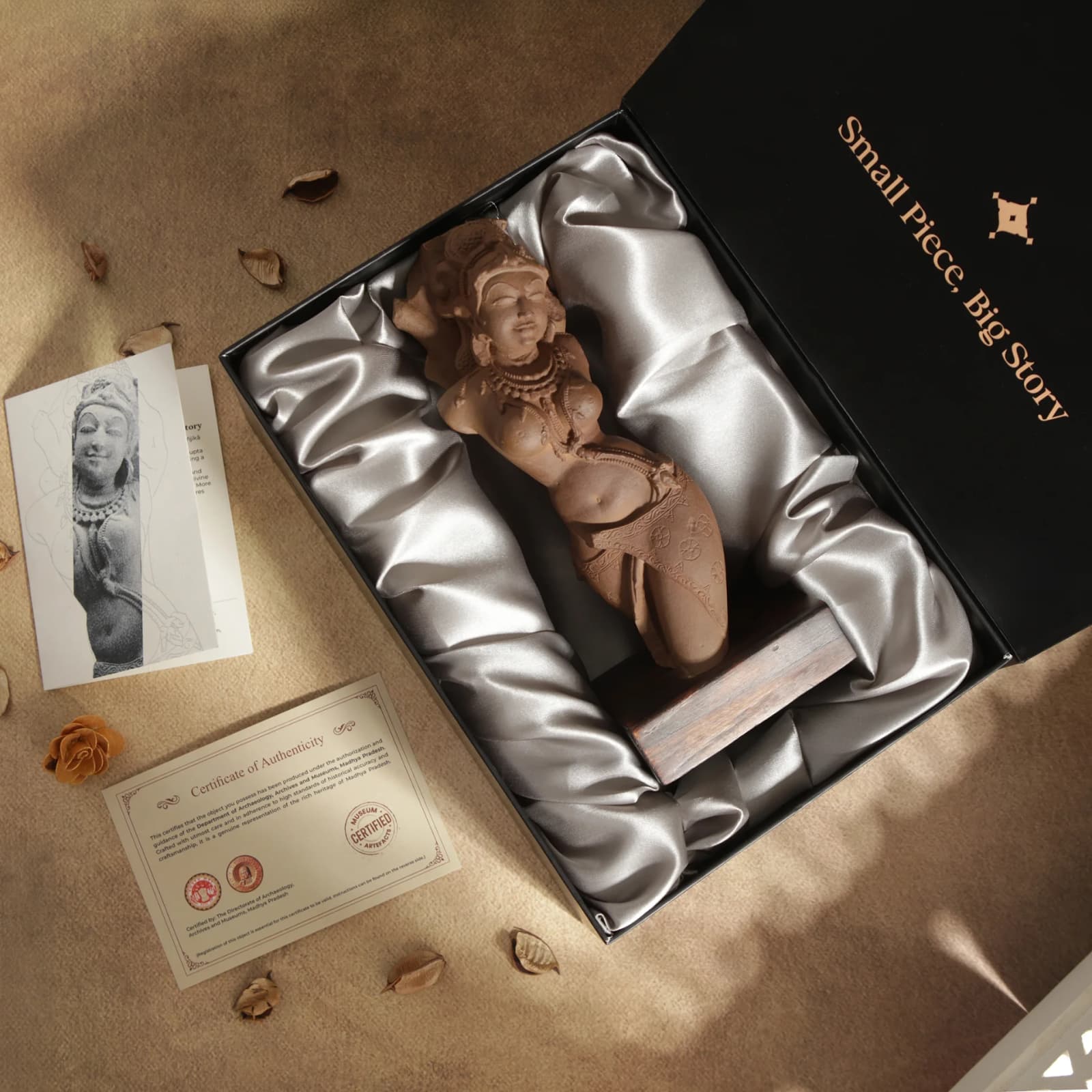 A Salabhanjika Sculpture replica nestled in a silk-lined gift box with an authenticity certificate and informational card.