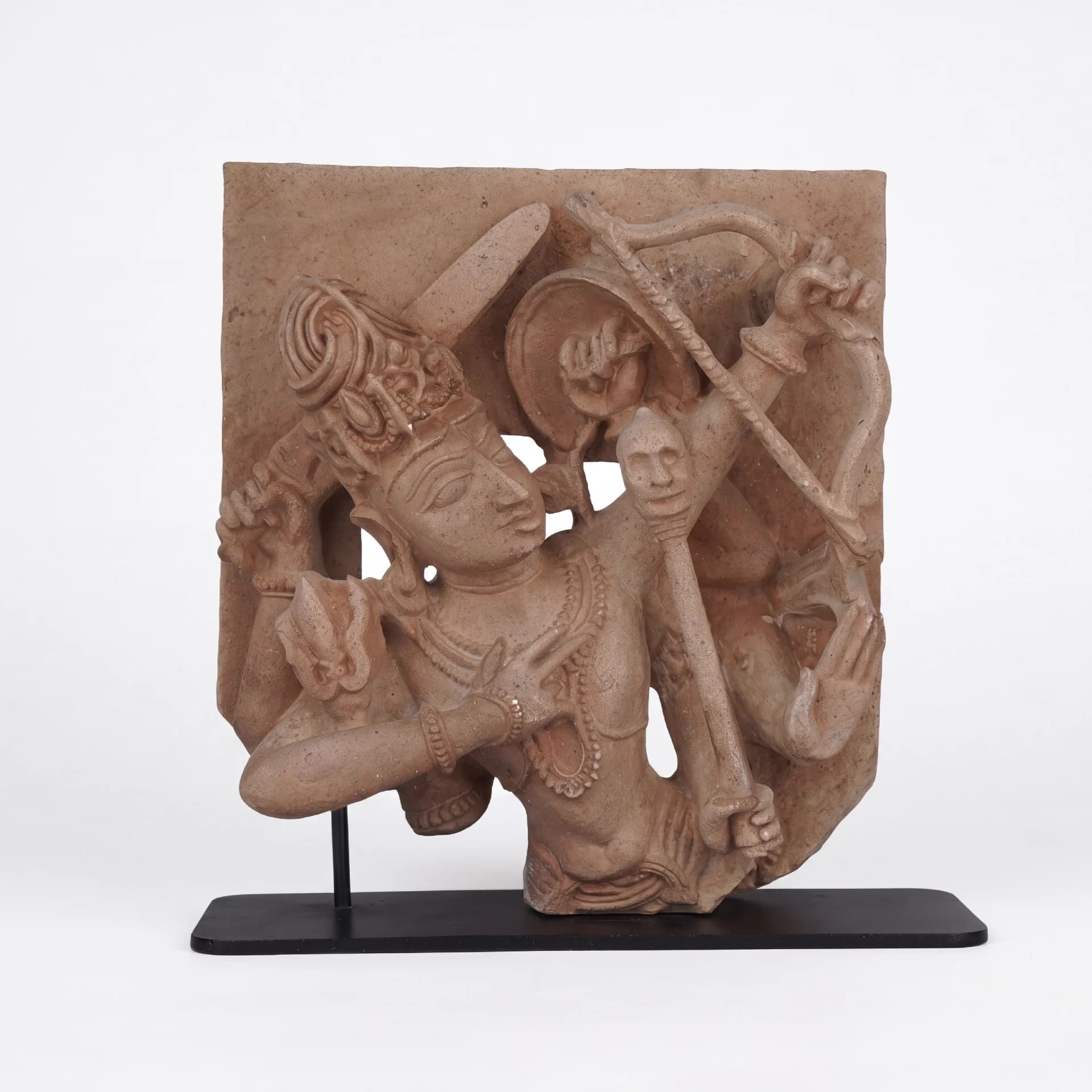 A front-facing view of the Tripurantaka Shiva stone composite sculpture, showing the deity holding a bow and arrow.