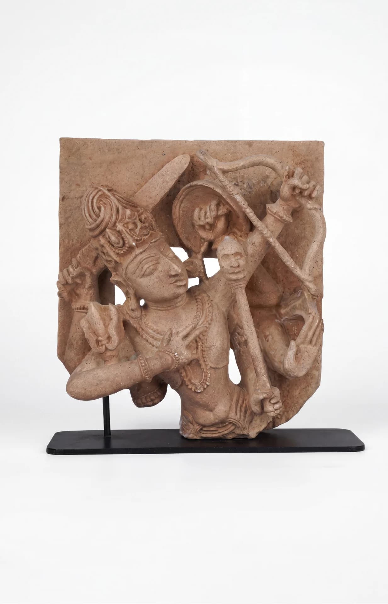A stone composite Tripurantaka Shiva sculpture showing the deity holding a bow, mounted on a black metal stand.