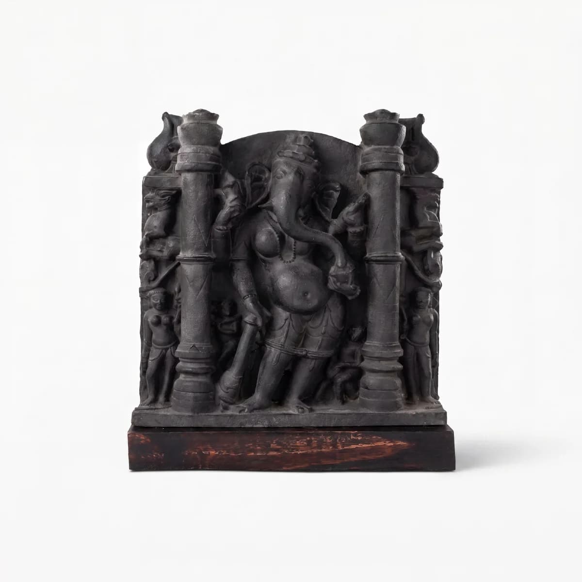 A museum-grade Vinayaki Sculpture replica featuring intricate dark stone carving of the elephant-headed deity standing between two pillars.