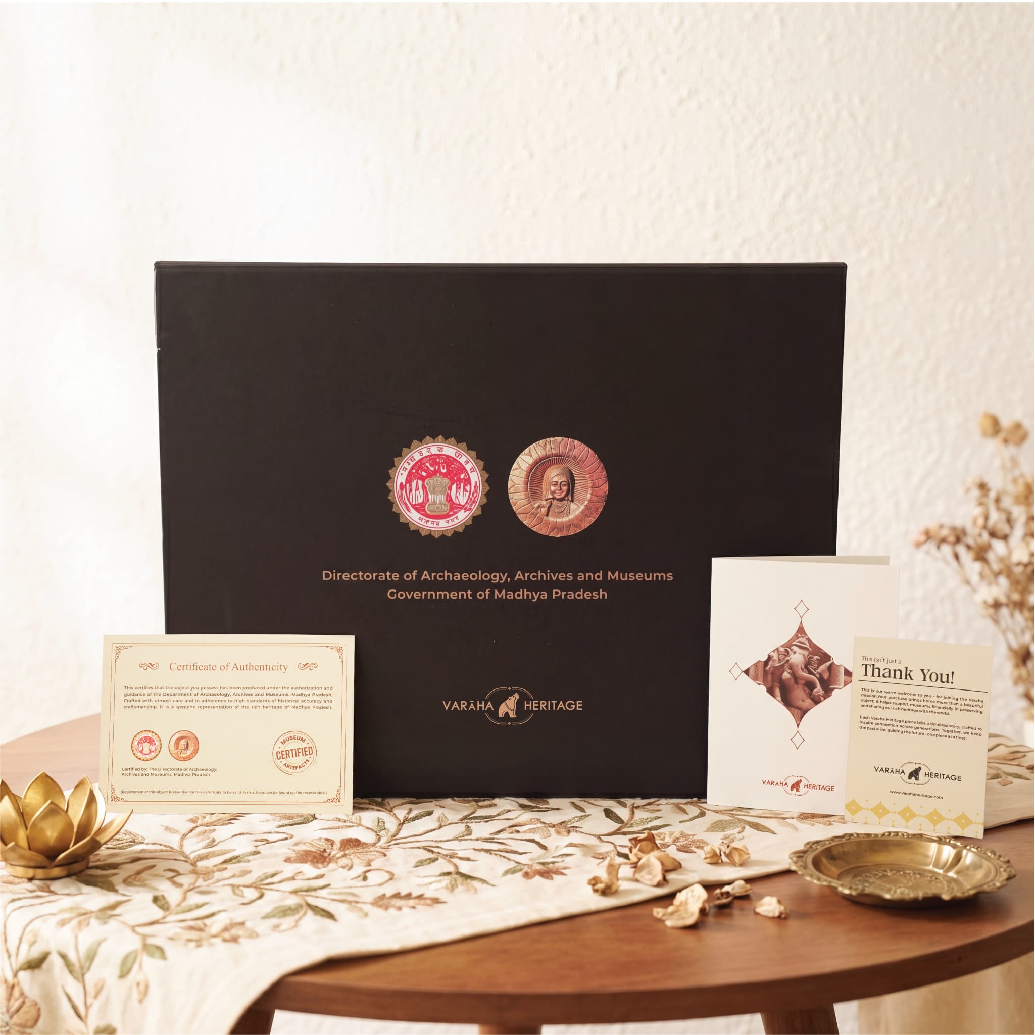 A black presentation box for the Vinayaki Sculpture replica, accompanied by a certificate of authenticity and a thank you card.
