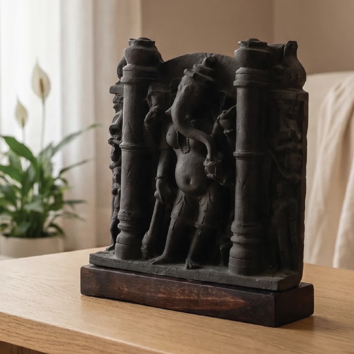 A three-quarter view of the Vinayaki Sculpture, a dark stone museum replica featuring intricate medieval Indian temple iconography.