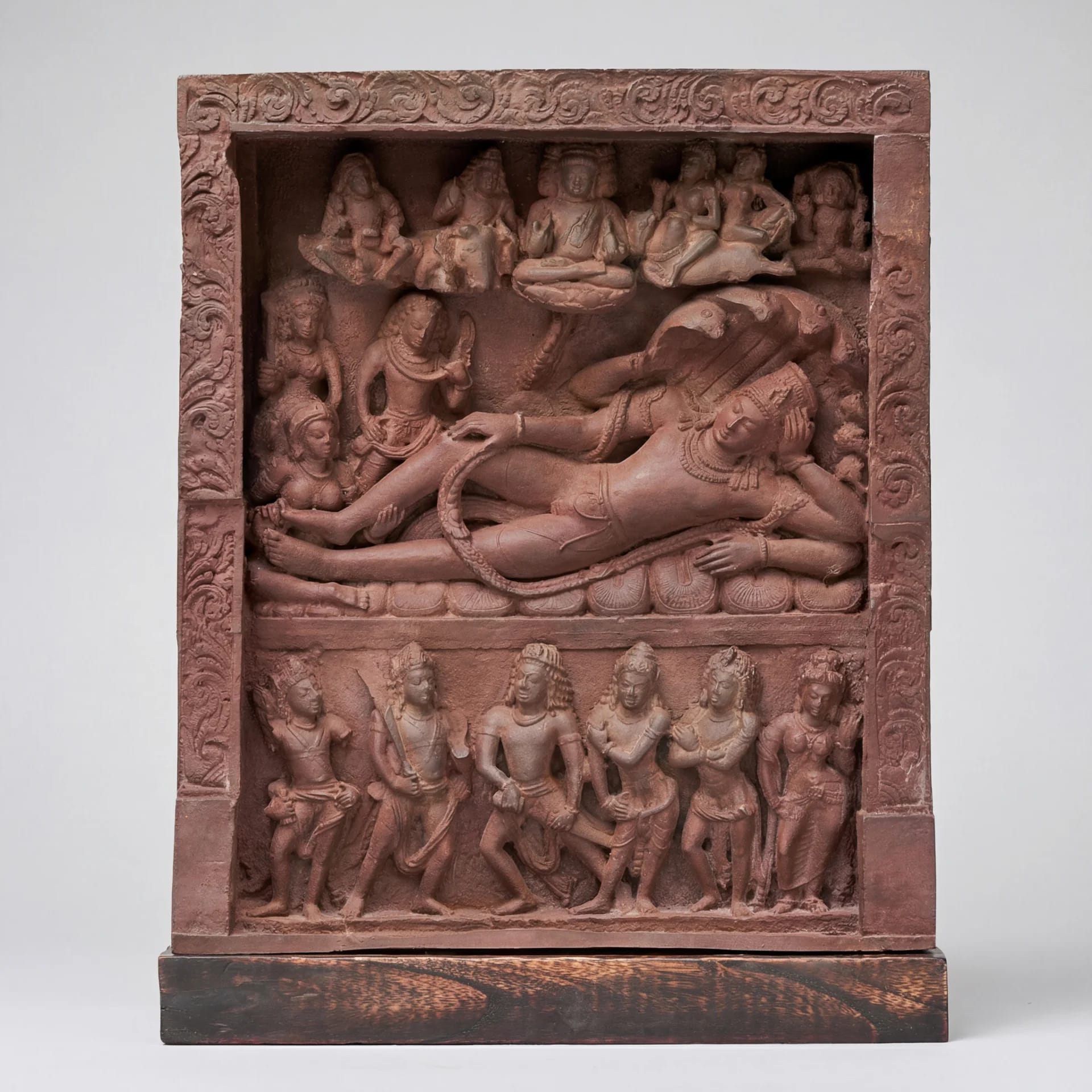 A detailed terracotta-style Anantasayana Vishnu Sculpture showing the deity reclining on a serpent within an ornate temple niche.