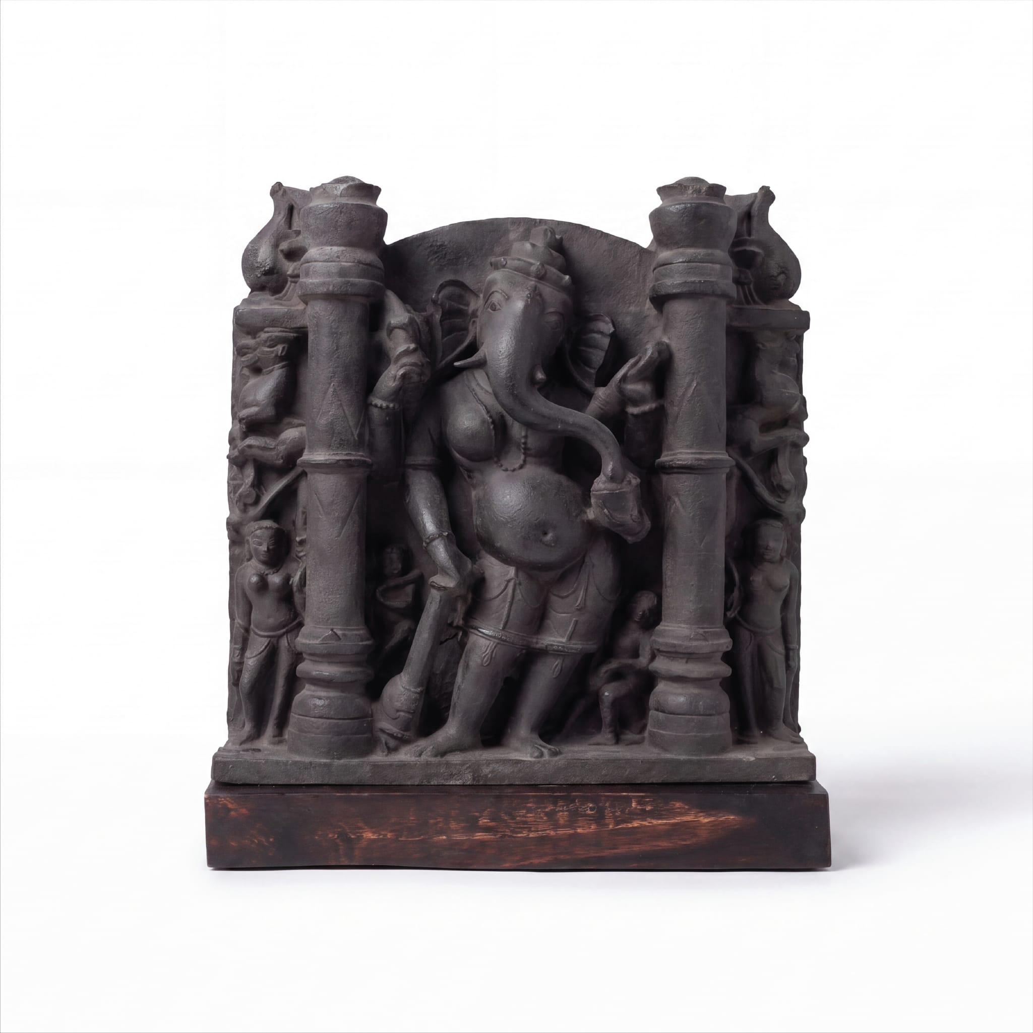A museum-grade Vinayaki Sculpture replica featuring intricate dark stone carving of the elephant-headed deity standing between two pillars.