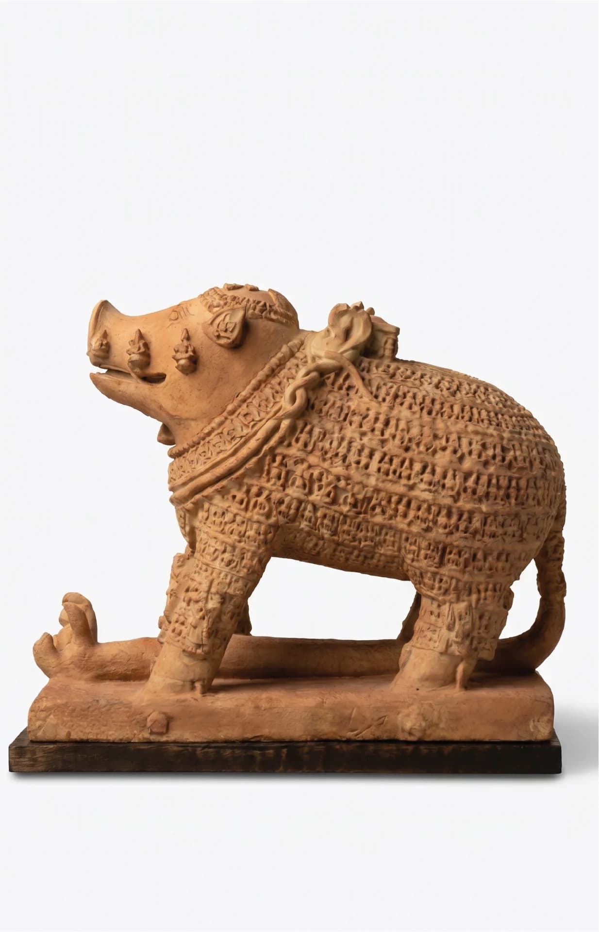 A side profile of the Adi Varaha Sculpture, a terracotta-style museum replica showing intricate carvings of deities across the boar's body.