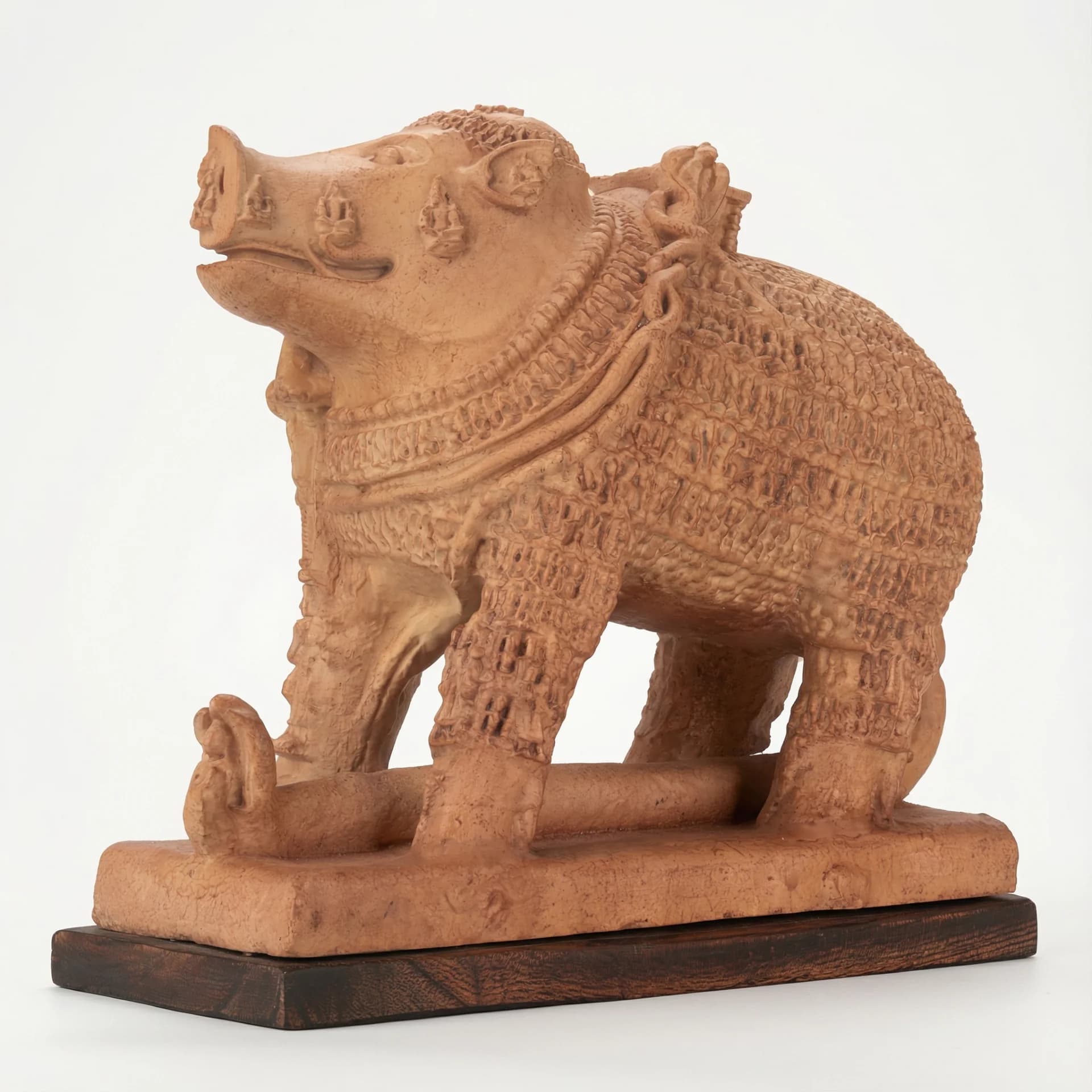 A side-profile view of the Adi Varaha Sculpture, a terracotta-style replica featuring intricate carvings of the boar-headed Vishnu avatar.