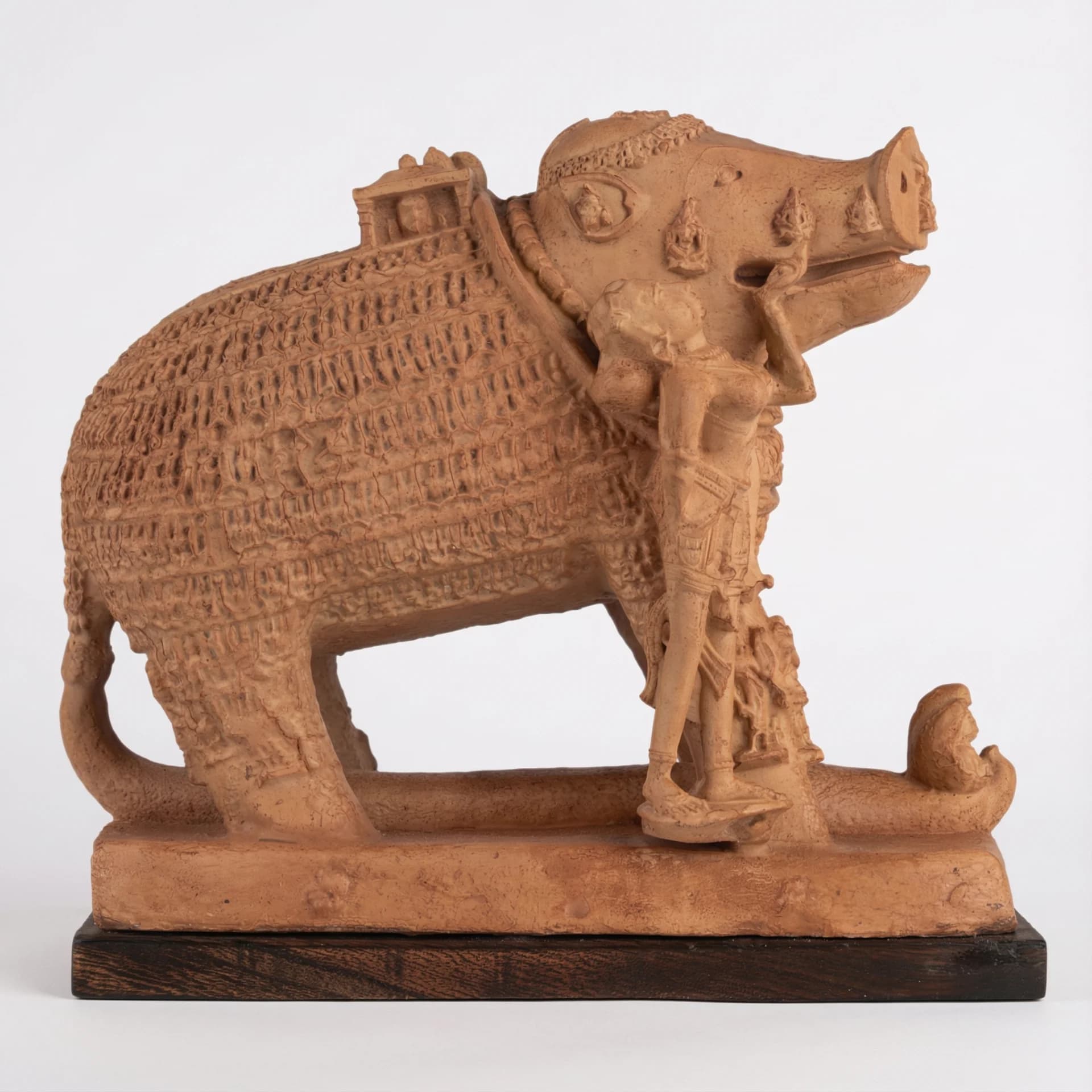 A side profile of the Adi Varaha Sculpture, a terracotta-style replica showing Vishnu as a boar rescuing Bhudevi.