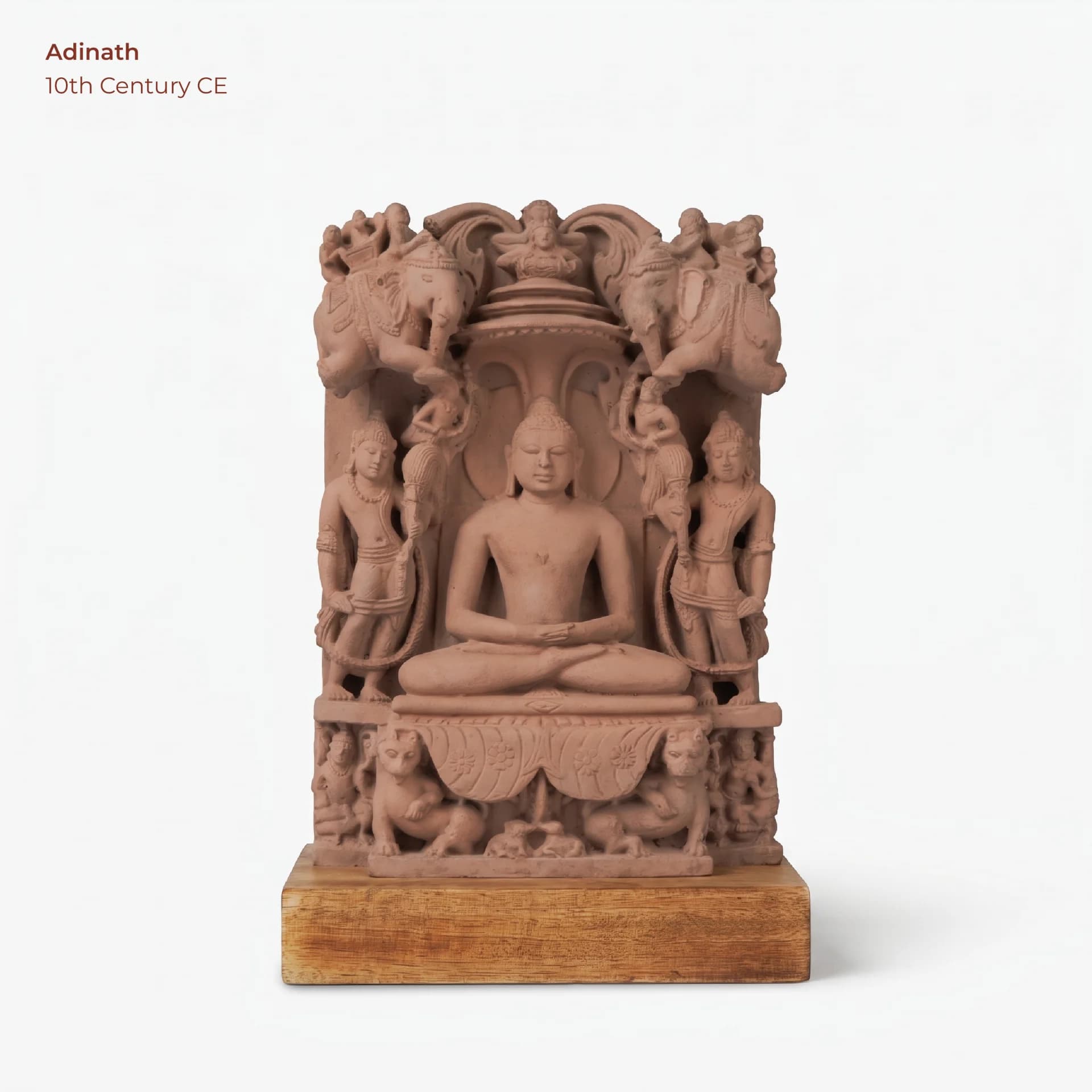 A stone composite Adinath Sculpture featuring the Tirthankara in padmasana, flanked by attendants and elephants on a wooden base.
