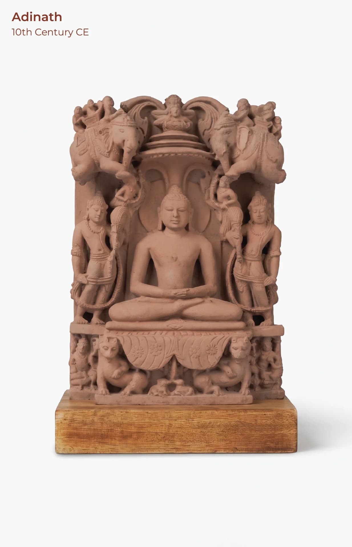 A front view of the Adinath Sculpture, a stone composite museum replica featuring a seated Tirthankara with intricate carvings.