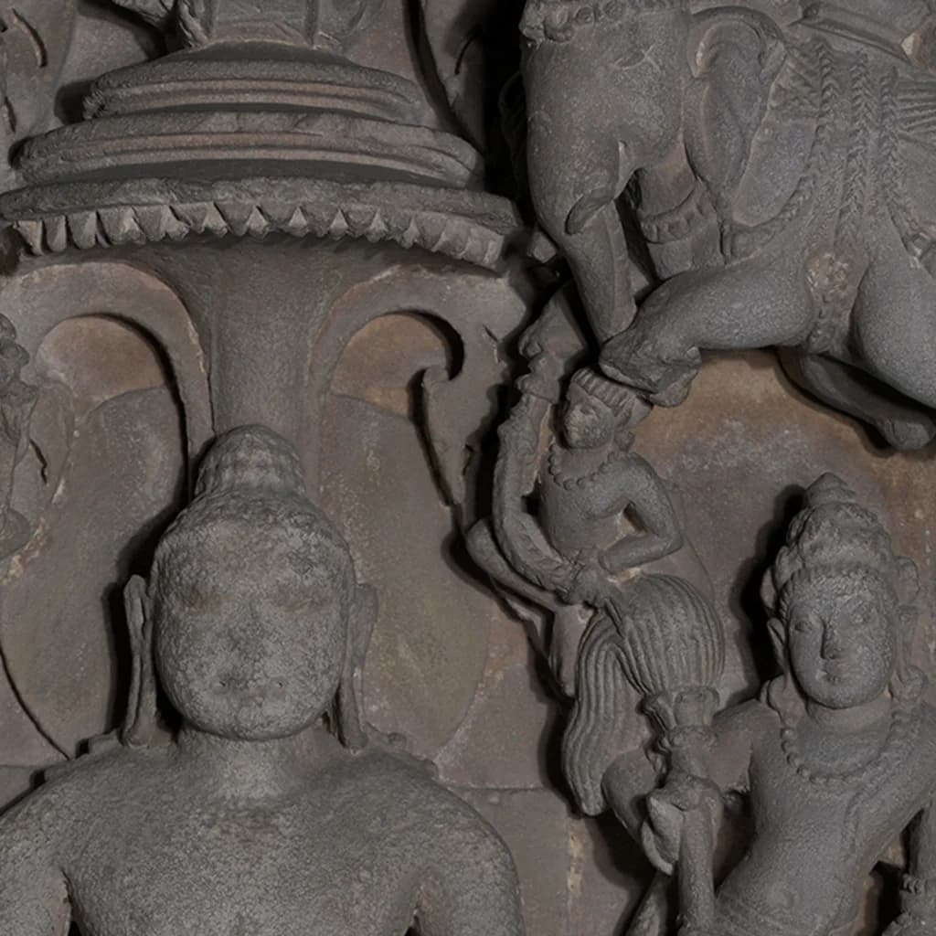Close-up of the Adinath Sculpture showing intricate stone composite carvings of the Tirthankara and attendant figures.