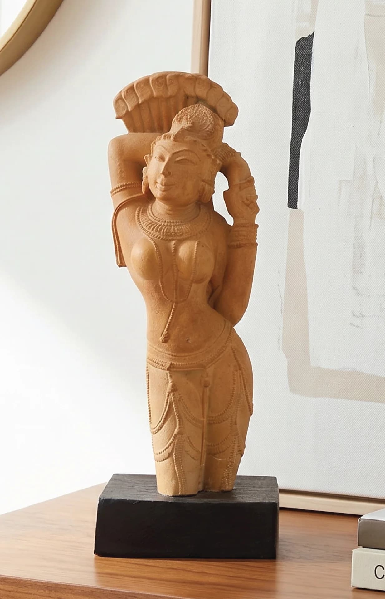 The Alasa Nayika Sculpture stands on a dark base, showcasing a hand-finished stone composite figure in a graceful pose.