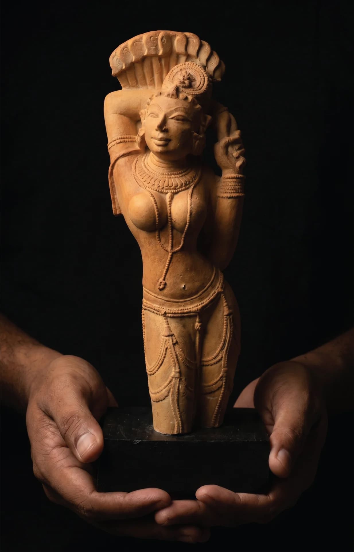 Hands hold the Alasa Nayika Sculpture, a stone composite replica featuring an elegant celestial maiden in a traditional tribhanga pose.
