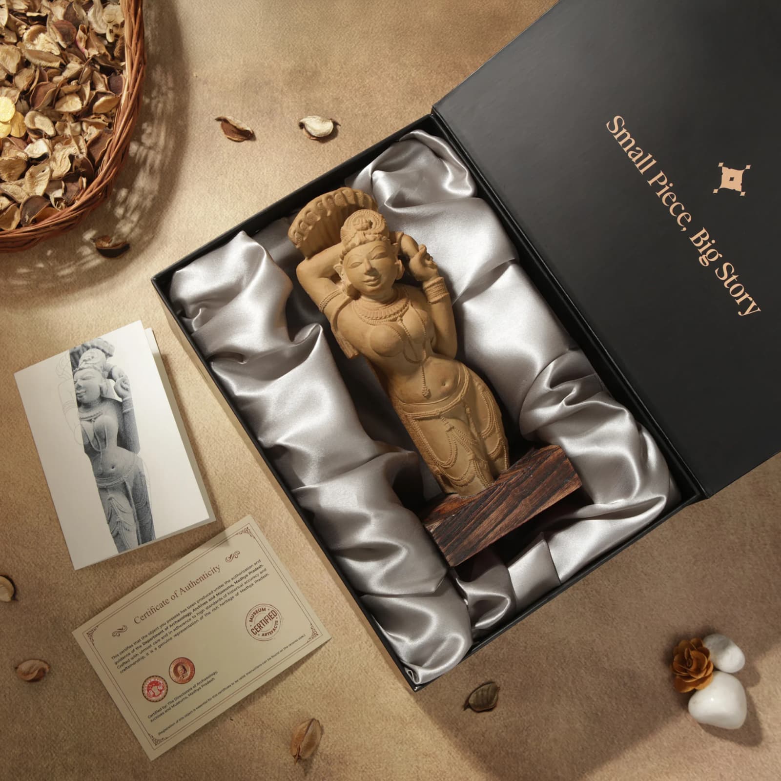 An Alasa Nayika Sculpture replica nestled in a satin-lined gift box, accompanied by a certificate of authenticity and card.
