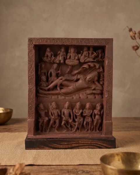 A front-facing view of the Anantasayana Vishnu Sculpture, a terracotta-style museum replica featuring intricate relief carvings of deities.