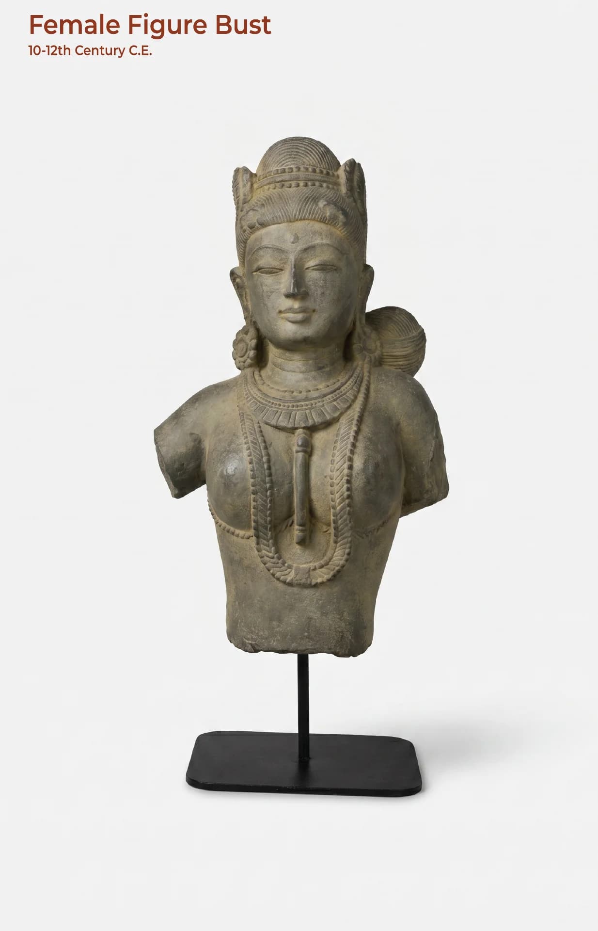 A front-facing view of the Female Figure Bust Sculpture, a stone composite replica showcasing intricate Chola-style jewelry and serene facial features.