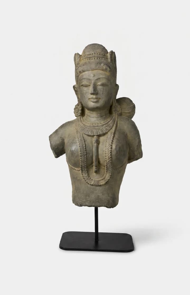 A front-facing view of the Female Figure Bust Sculpture, a stone composite replica featuring intricate Chola-style jewelry and detailing.