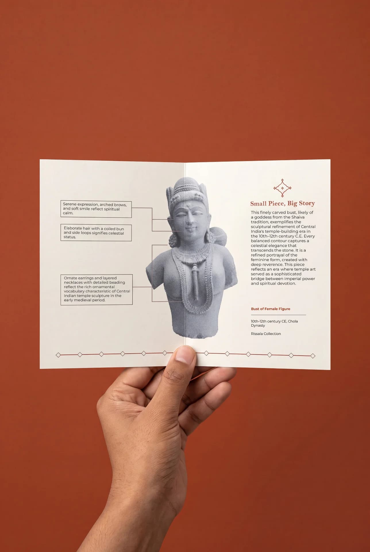 A hand holds an informational brochure featuring the Female Figure Bust Sculpture, highlighting its stone composite craftsmanship and historical details.