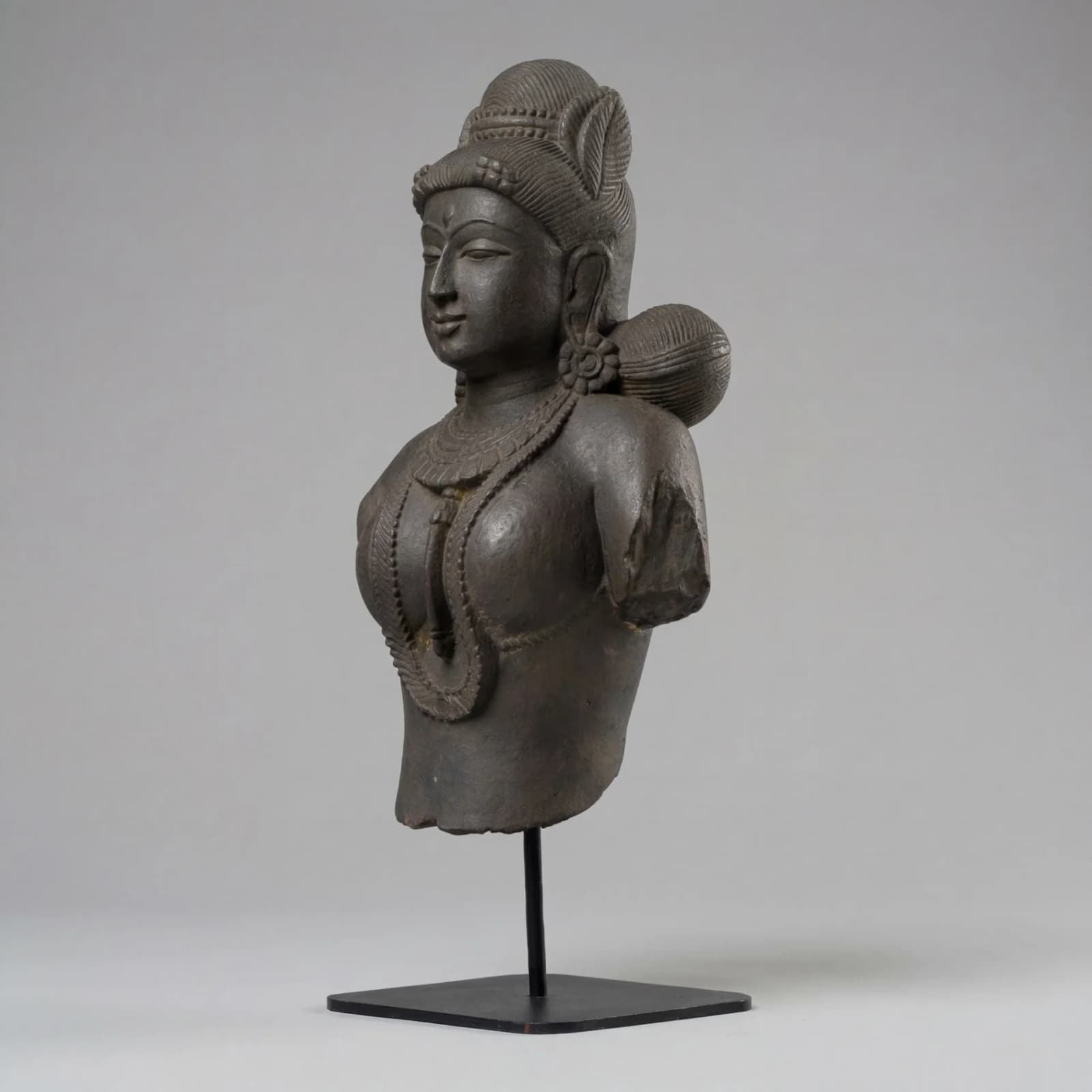 A three-quarter view of the Female Figure Bust Sculpture, showcasing the intricate Chola style and hand-finished stone composite texture.