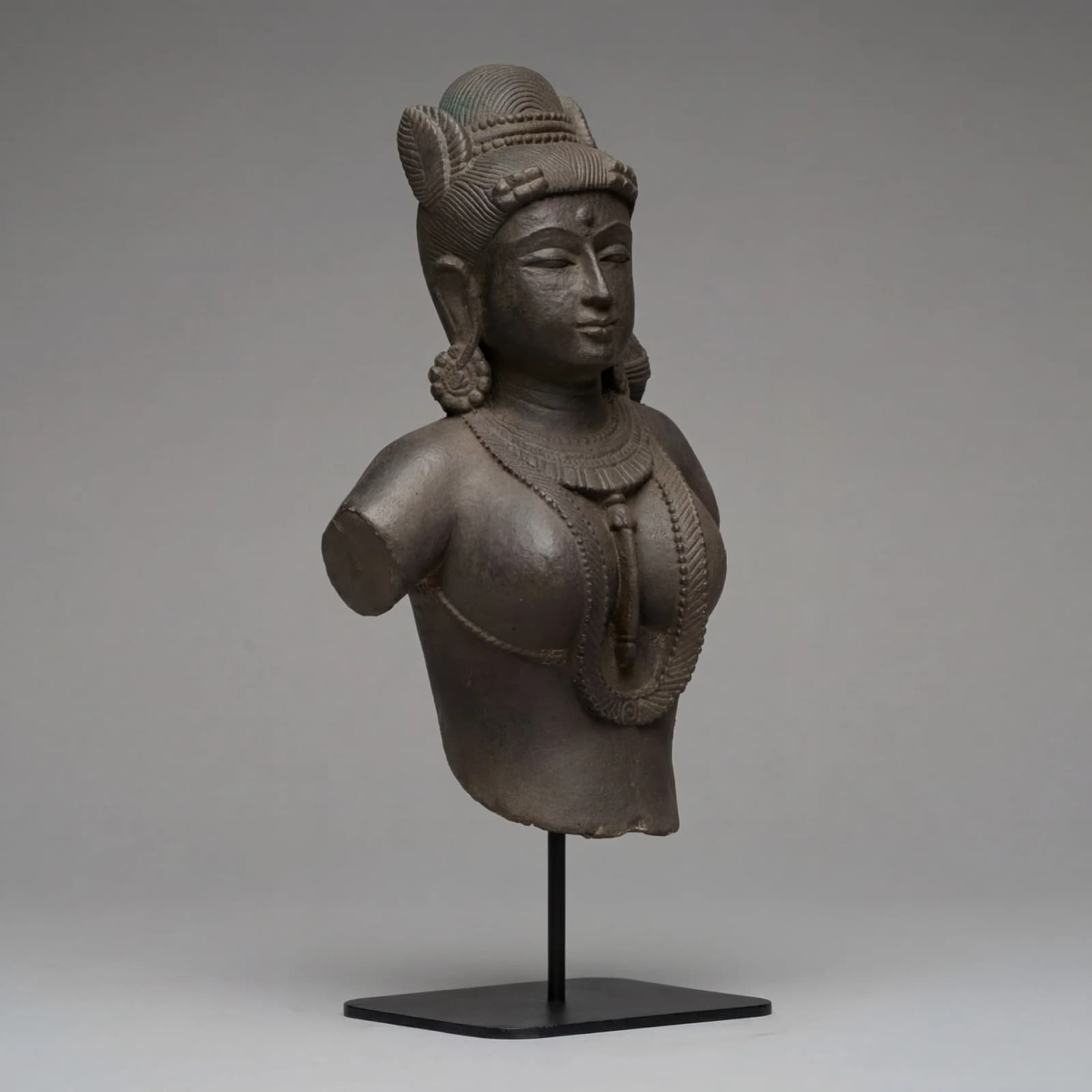 A three-quarter view of the Female Figure Bust Sculpture, showcasing the intricate Chola style details and hand-finished stone composite texture.