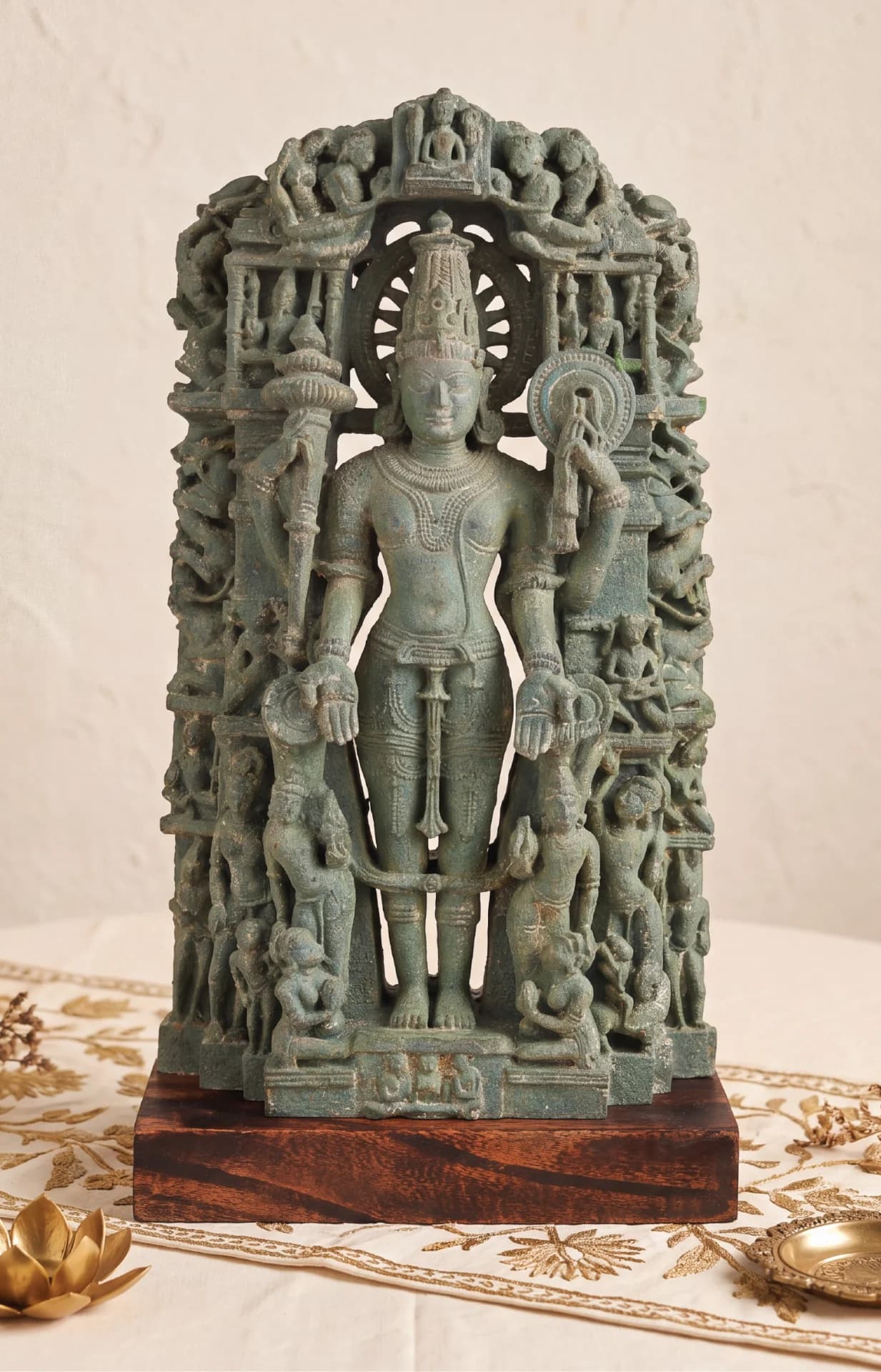 A front-facing view of the Chaturbhuj Vishnu Sculpture, a stone composite replica featuring intricate carvings of deities and traditional iconography.