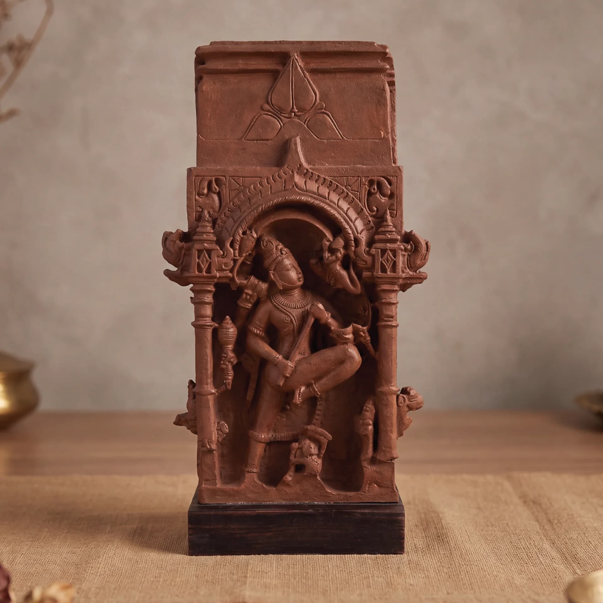 A front-view studio shot of the Gajasura Vadha Sculpture, a terracotta-style museum replica featuring intricate temple relief carvings.