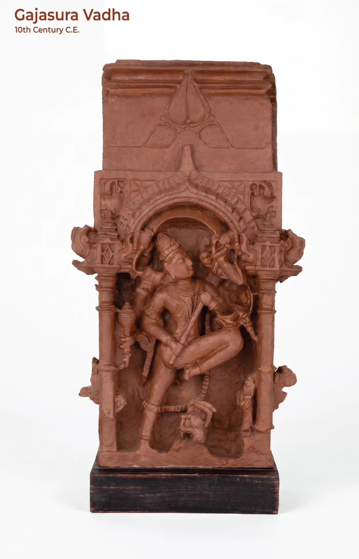 A full front view of the Gajasura Vadha sculpture, a terracotta-style museum replica depicting Shiva in a dynamic pose.