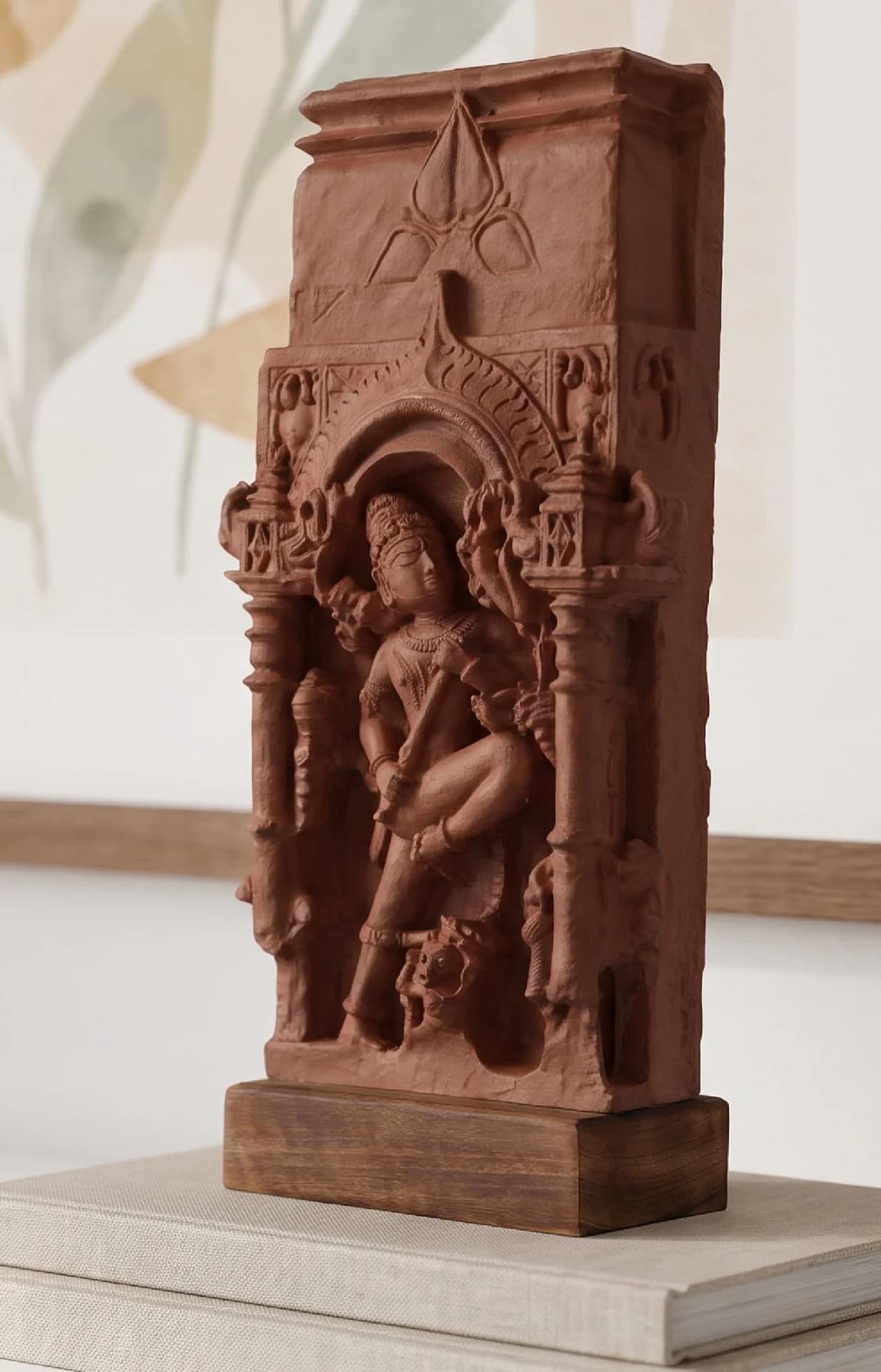 A three-quarter view of the Gajasura Vadha sculpture, a terracotta-style museum replica showing intricate temple relief carvings.