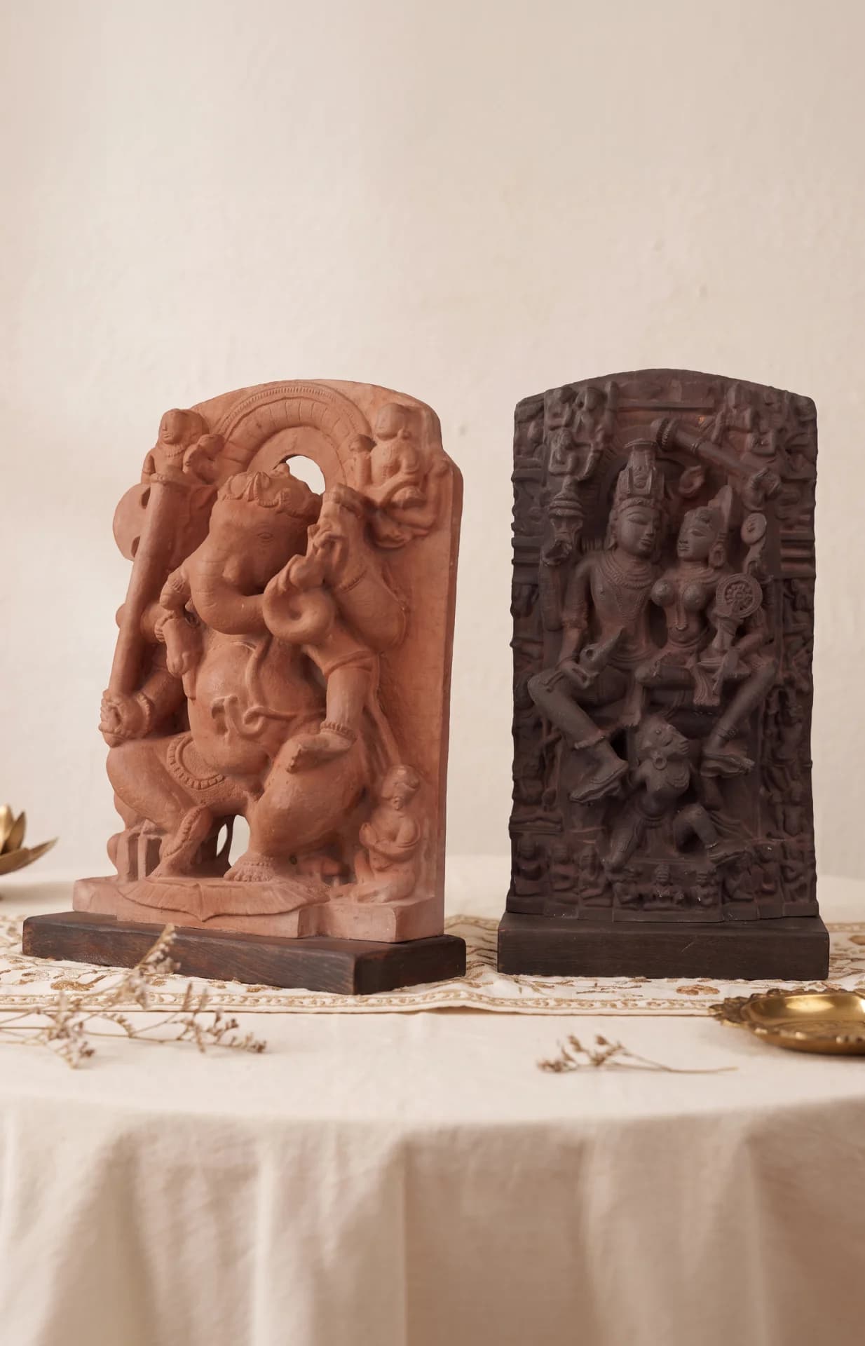 The Ganesha & Lakshmi Narayan Museum Masterpiece Replicas displayed together, showcasing intricate terracotta-style carvings on a neutral tabletop setting.