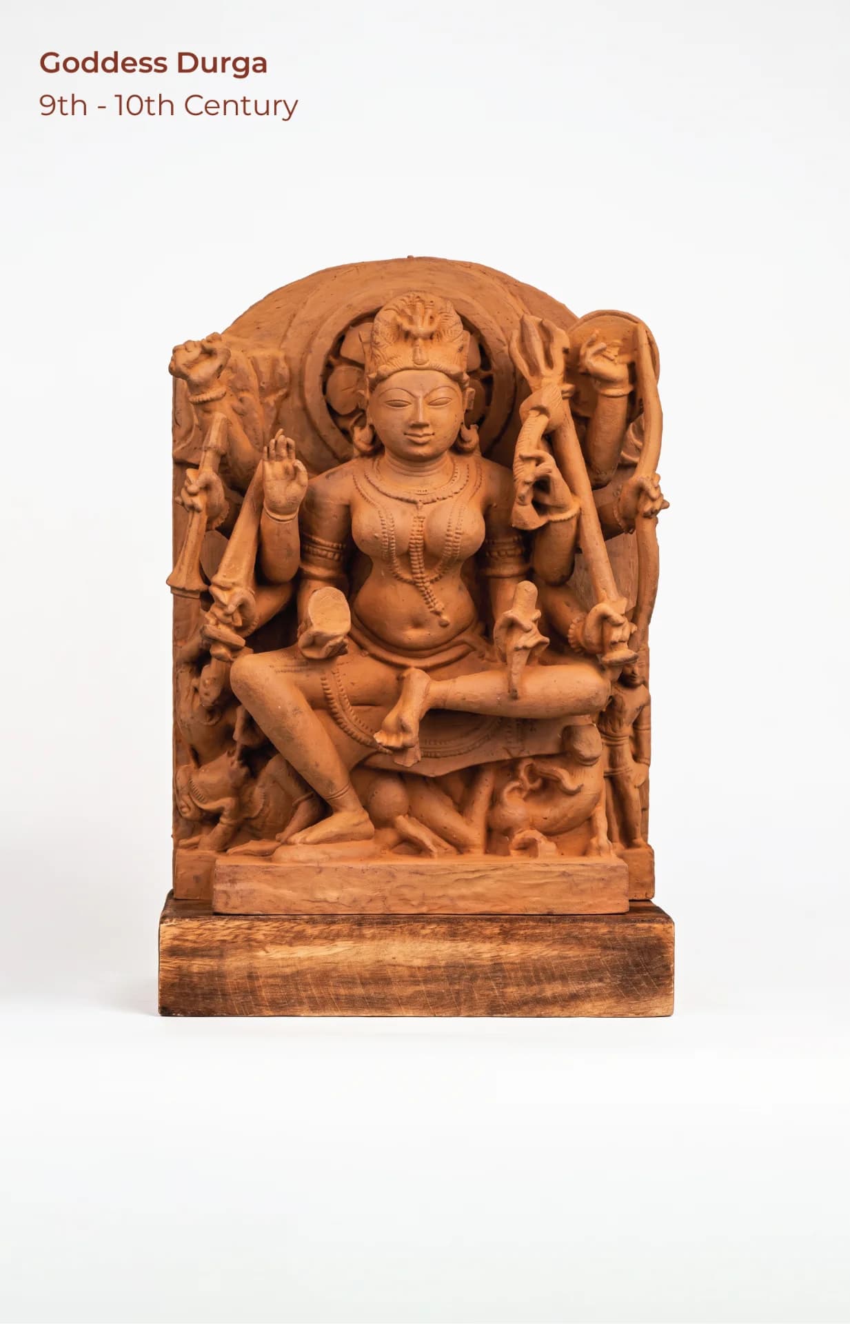 A front-facing view of the Goddess Durga Sculpture, a hand-finished stone replica featuring intricate medieval-style carvings and attendant figures.