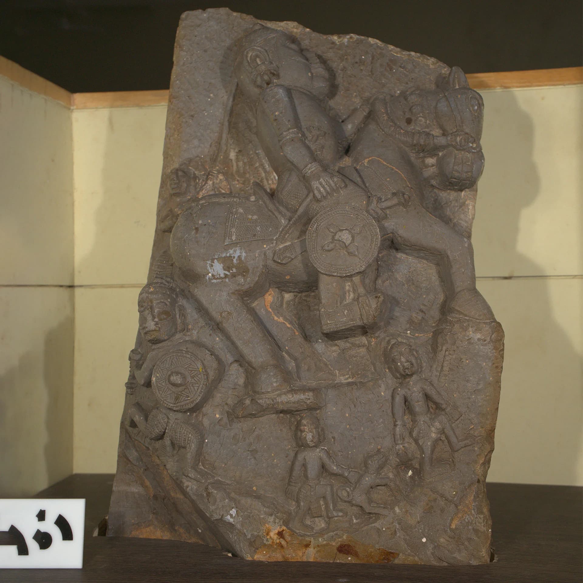The Goud Yoddha Sculpture features a detailed stone relief of a mounted warrior surrounded by smaller attendant figures.