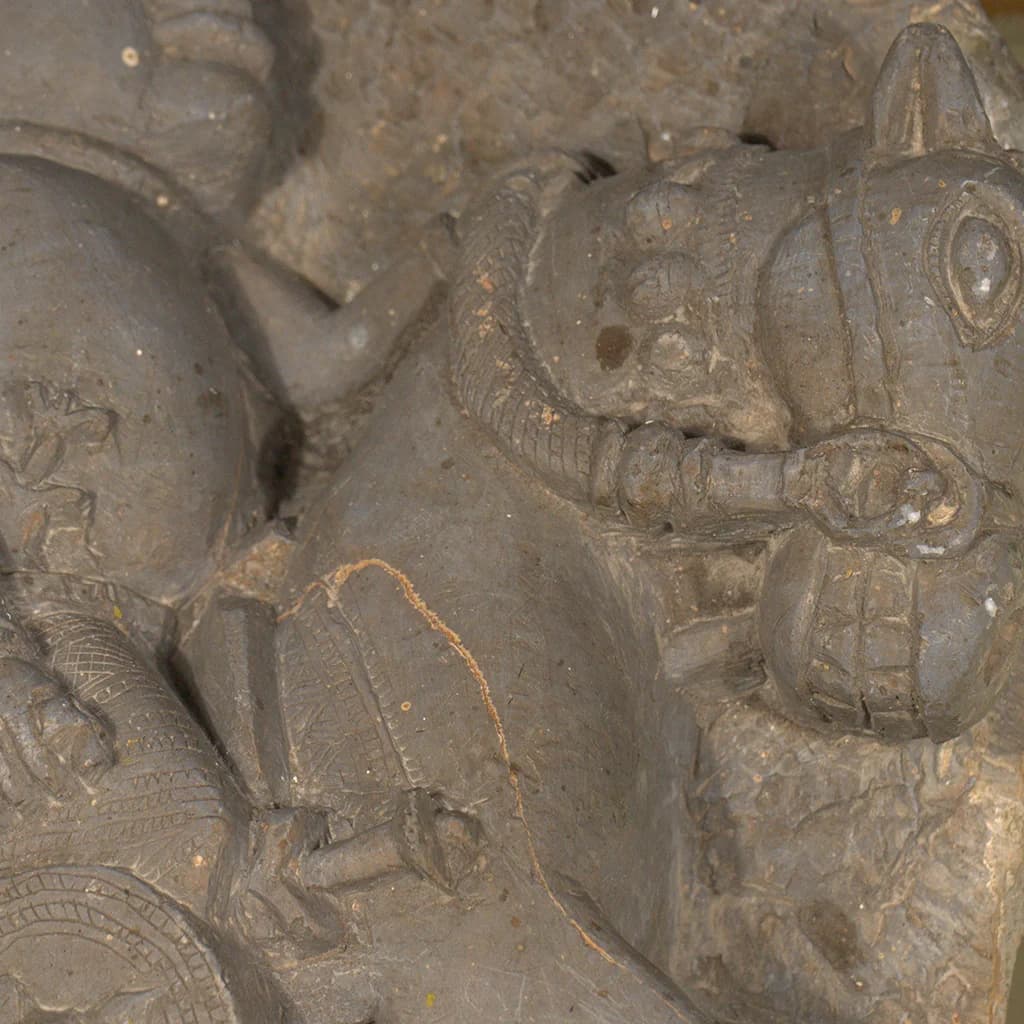 A detailed close-up of the Goud Yoddha Sculpture showing the stone-carved horse head with intricate bridle and harness details.