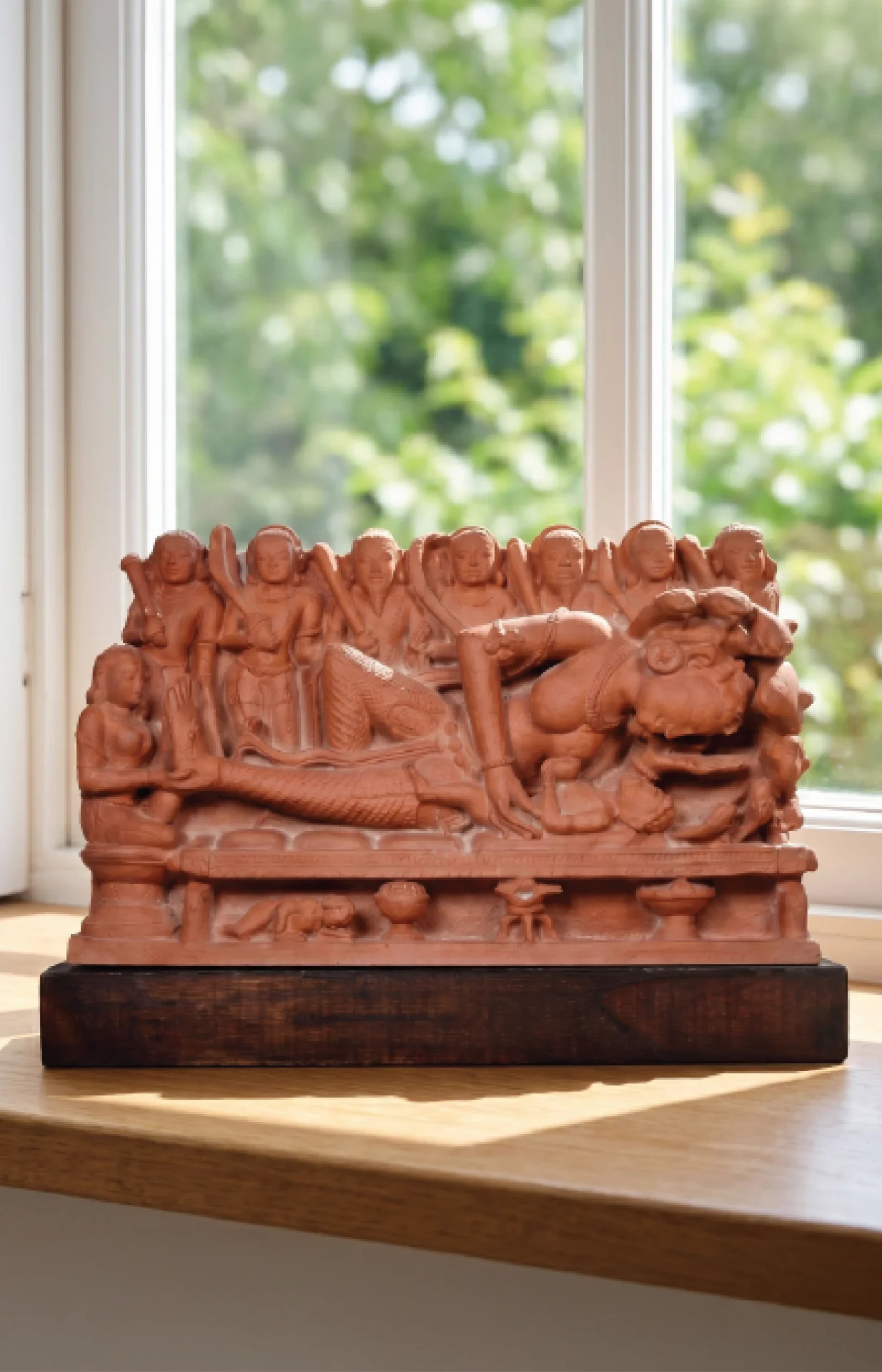 A front view of the Krishna's Birth Sculpture, a terracotta-style museum replica showing Devaki and soldiers in intricate detail.