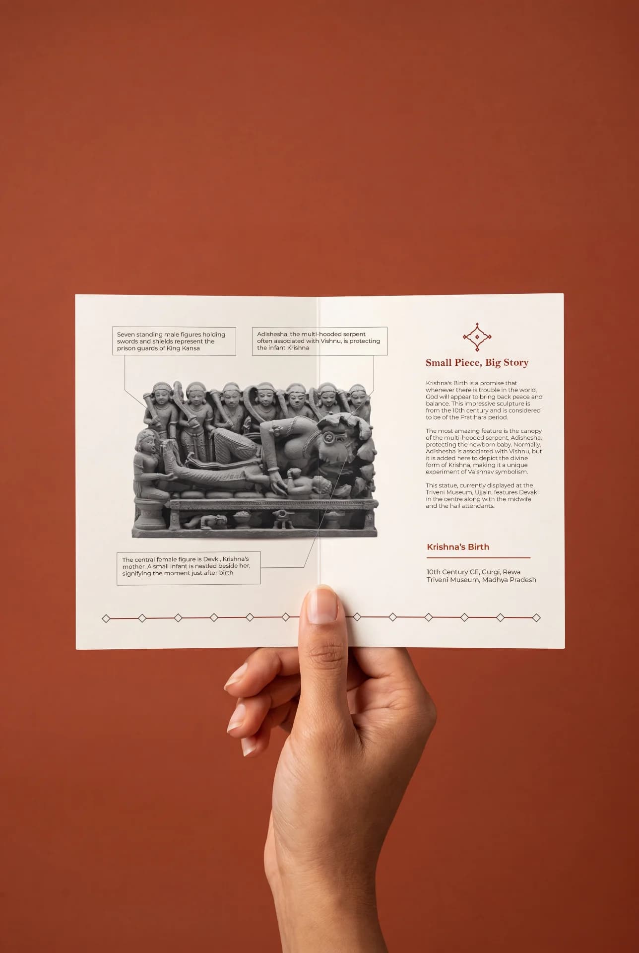 A hand holds an informational brochure featuring the Krishna's Birth Sculpture, a detailed stone-style museum replica with historical annotations.