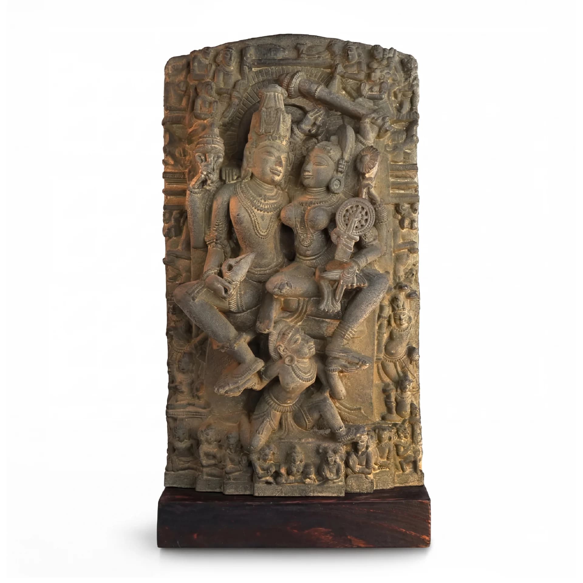 A front view of the Lakshmi Narayan Sculpture featuring intricate stone-carved deities on a dark wooden base.